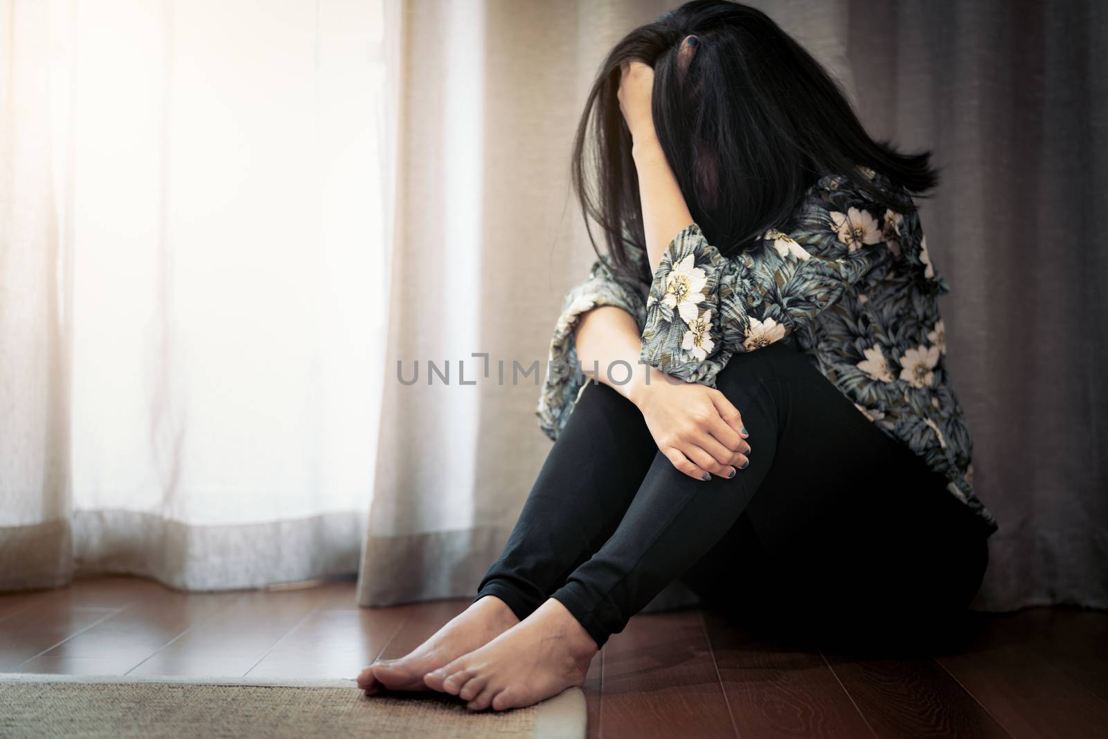 depressed women sitting near curtain in living room, alone, sadness, emotional concept