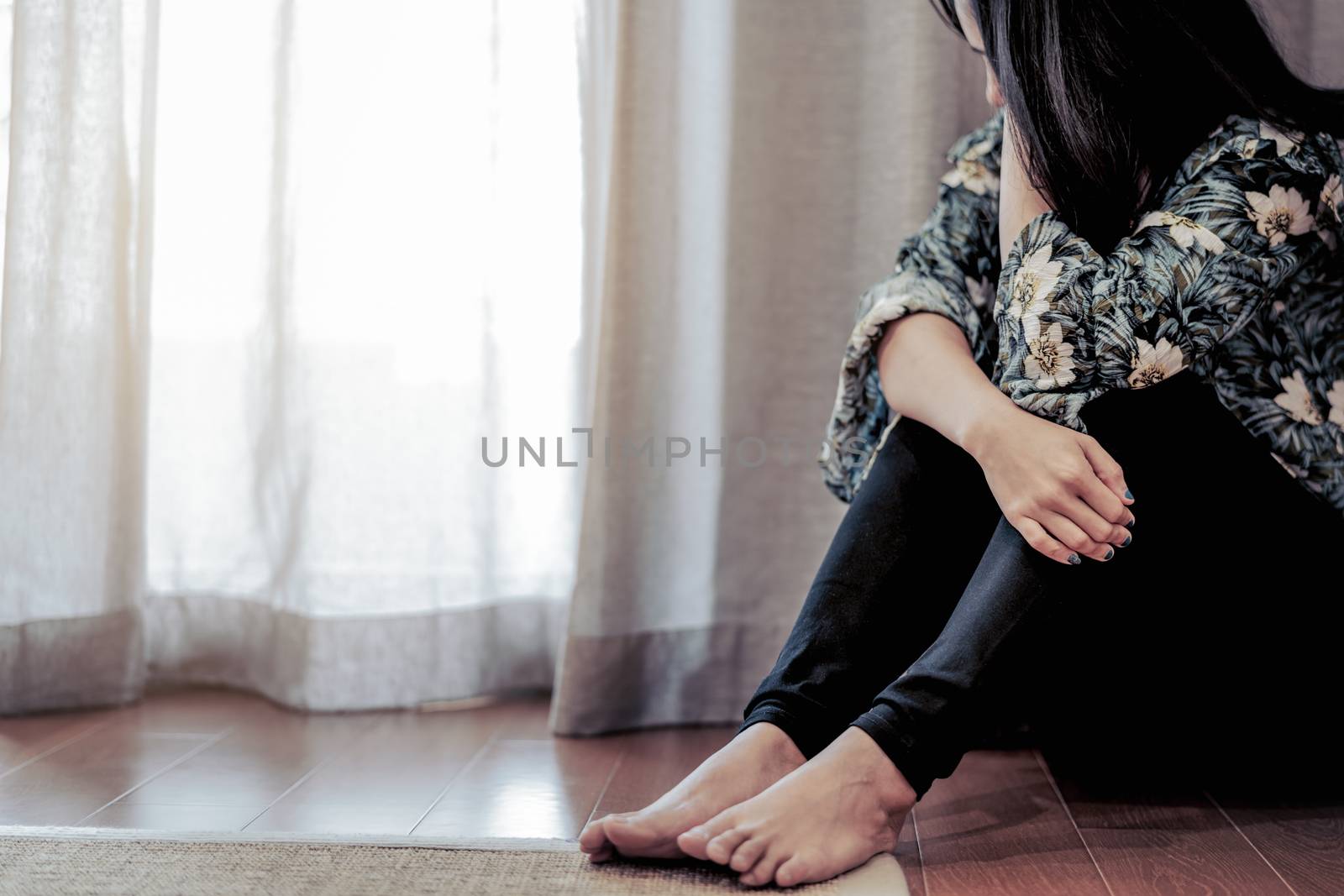 depressed women sitting near curtain in living room, alone, sadness, emotional concept