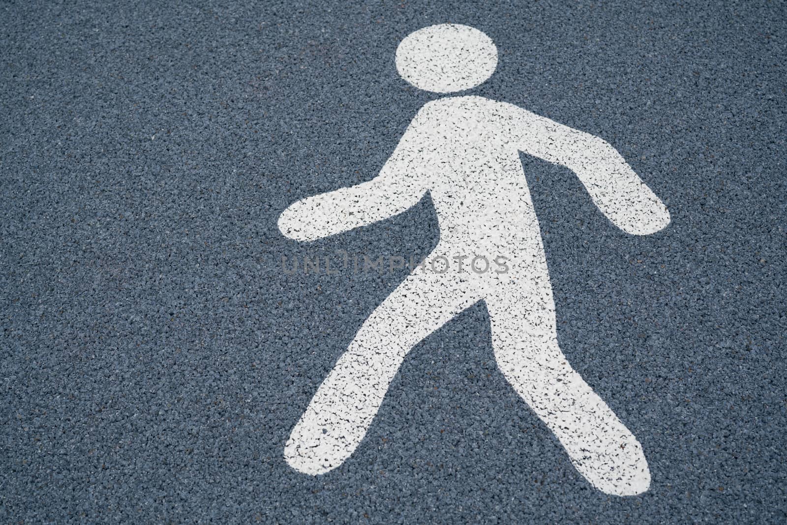 Walk sign, pedestrian street sign on a wet dark asphalt floor