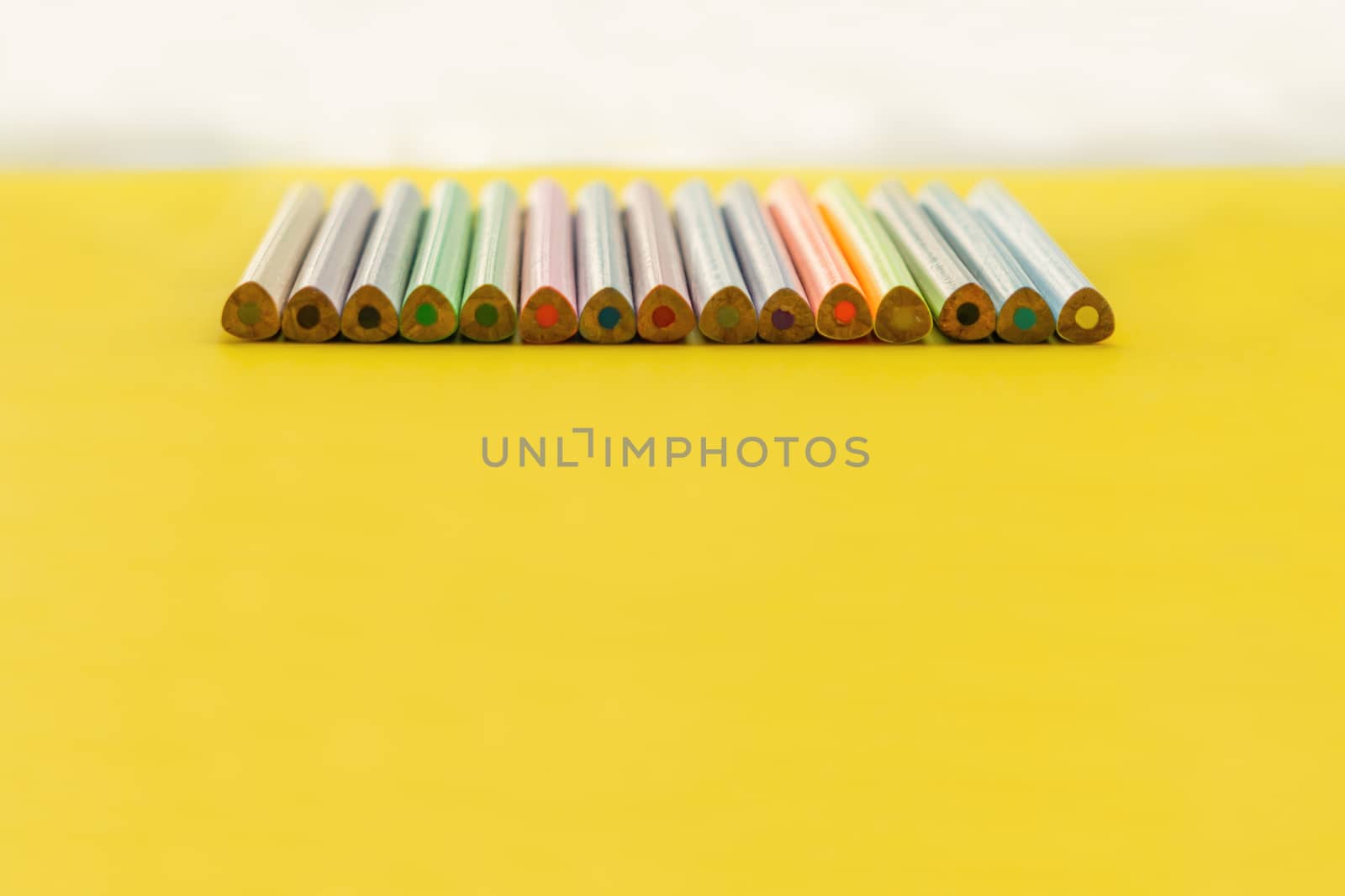 Diversity concept. row of mix color pencil on yellow background