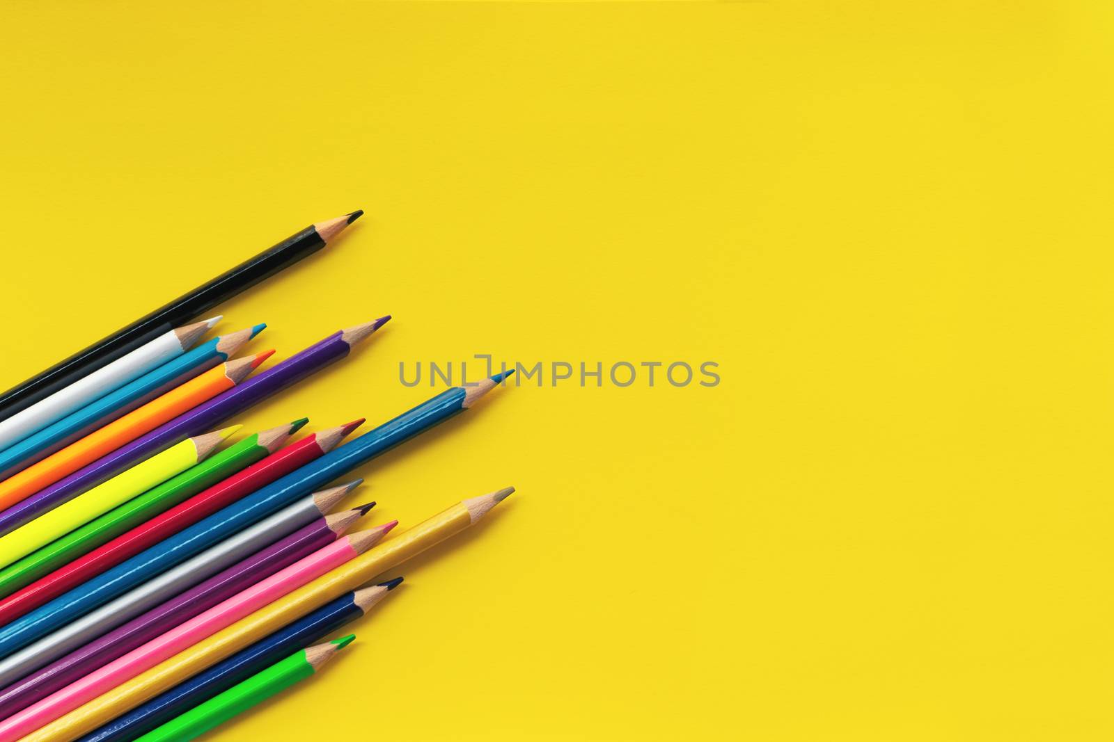 Community communication concept. Group of pencils on the yellow background with copy space