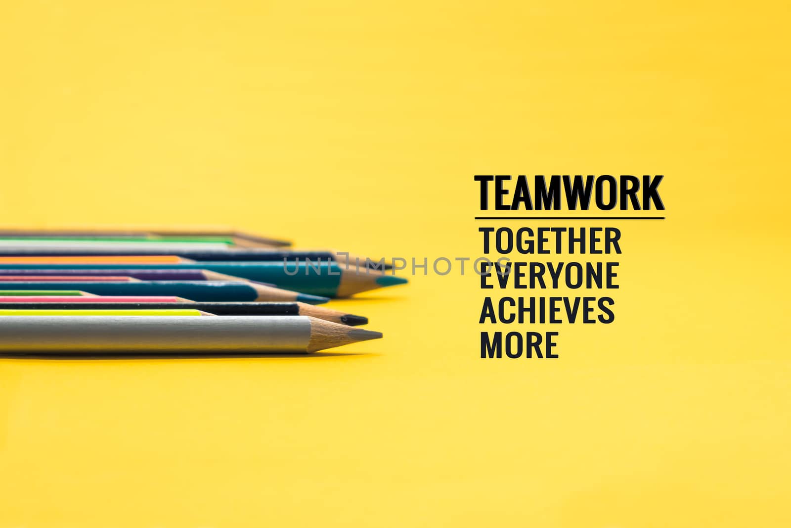 Teamwork concept. group of color pencil on yellow background with word Teamwork, Together, Everyone, Achieves and More