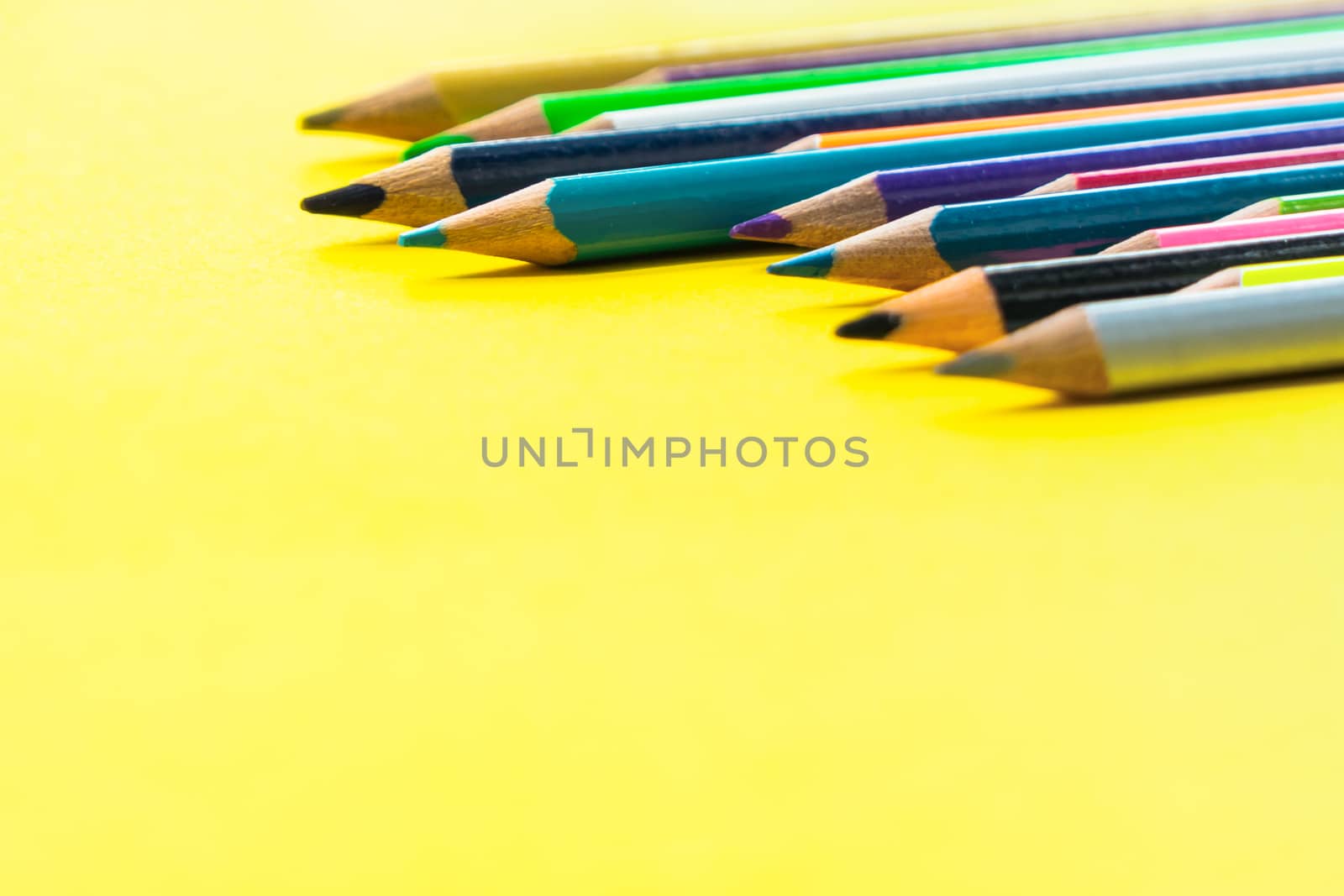 Teamwork concept. group of color pencil on yellow background