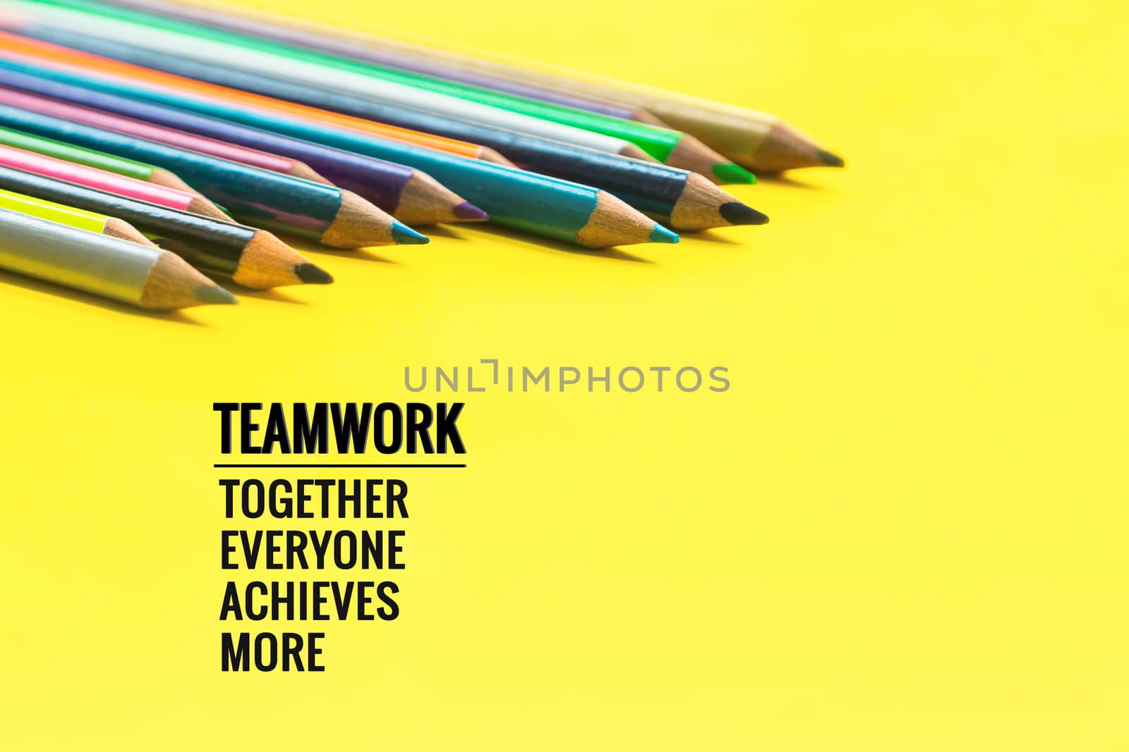 Teamwork concept. group of color pencil on yellow background with word Teamwork, Together, Everyone, Achieves and More