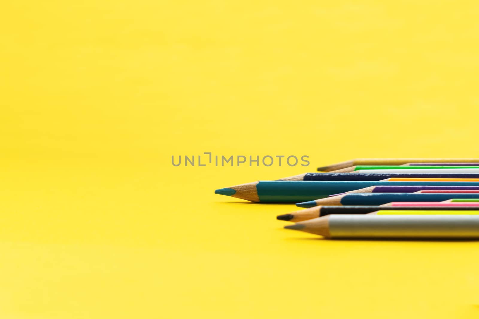 Leadership business concept. Blue color pencil lead other color on yellow background