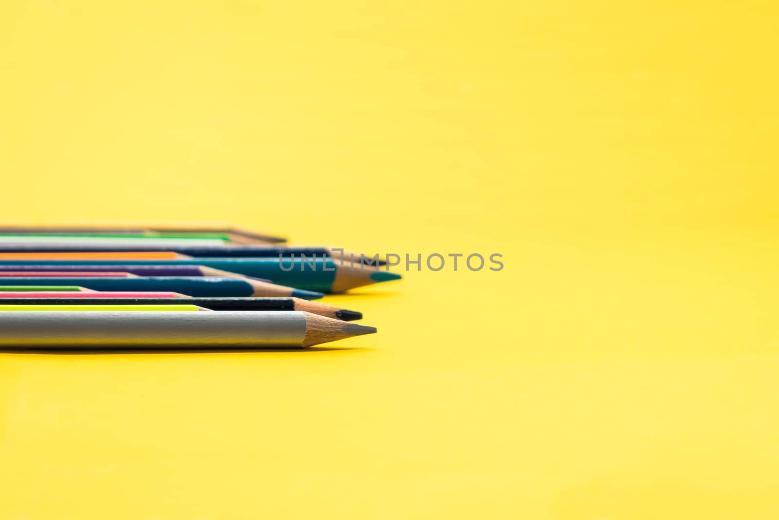 Teamwork concept. group of color pencil on yellow background