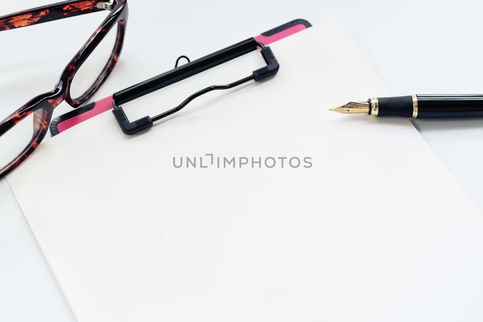 Business objects, clipboard with blank sheet of paper, pen, glasses on white background