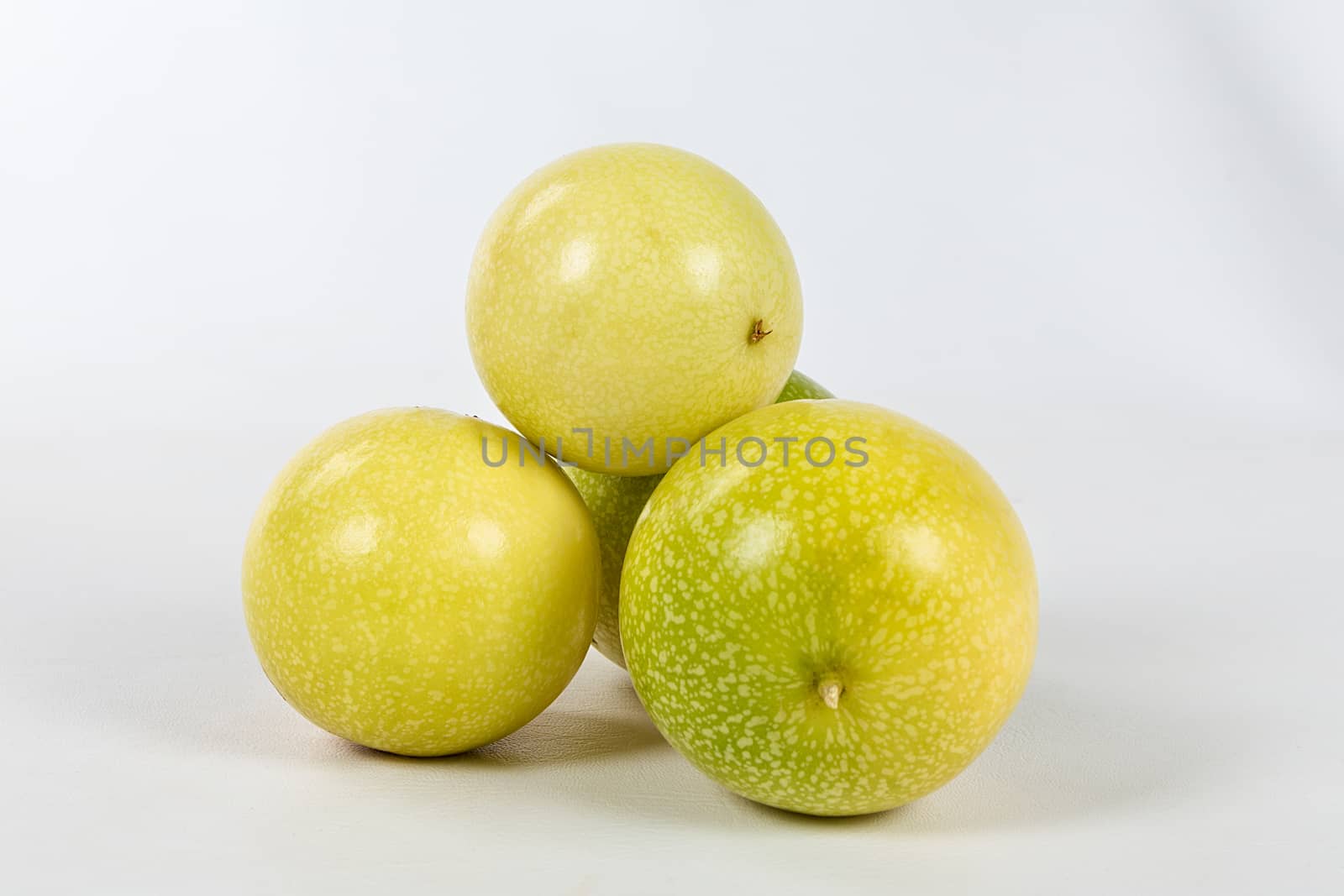 A group of four passion fruit  on a white background