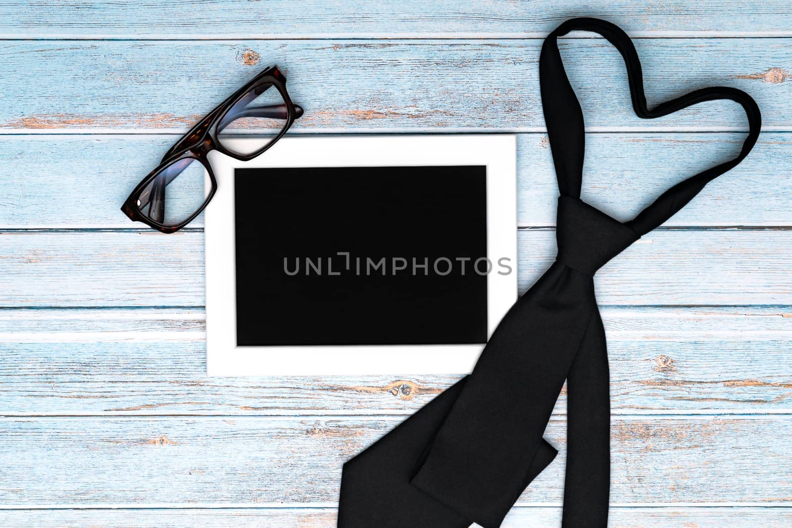 Happy fathers day greeting card with necktie and glasses on wooden table, Flat lay style