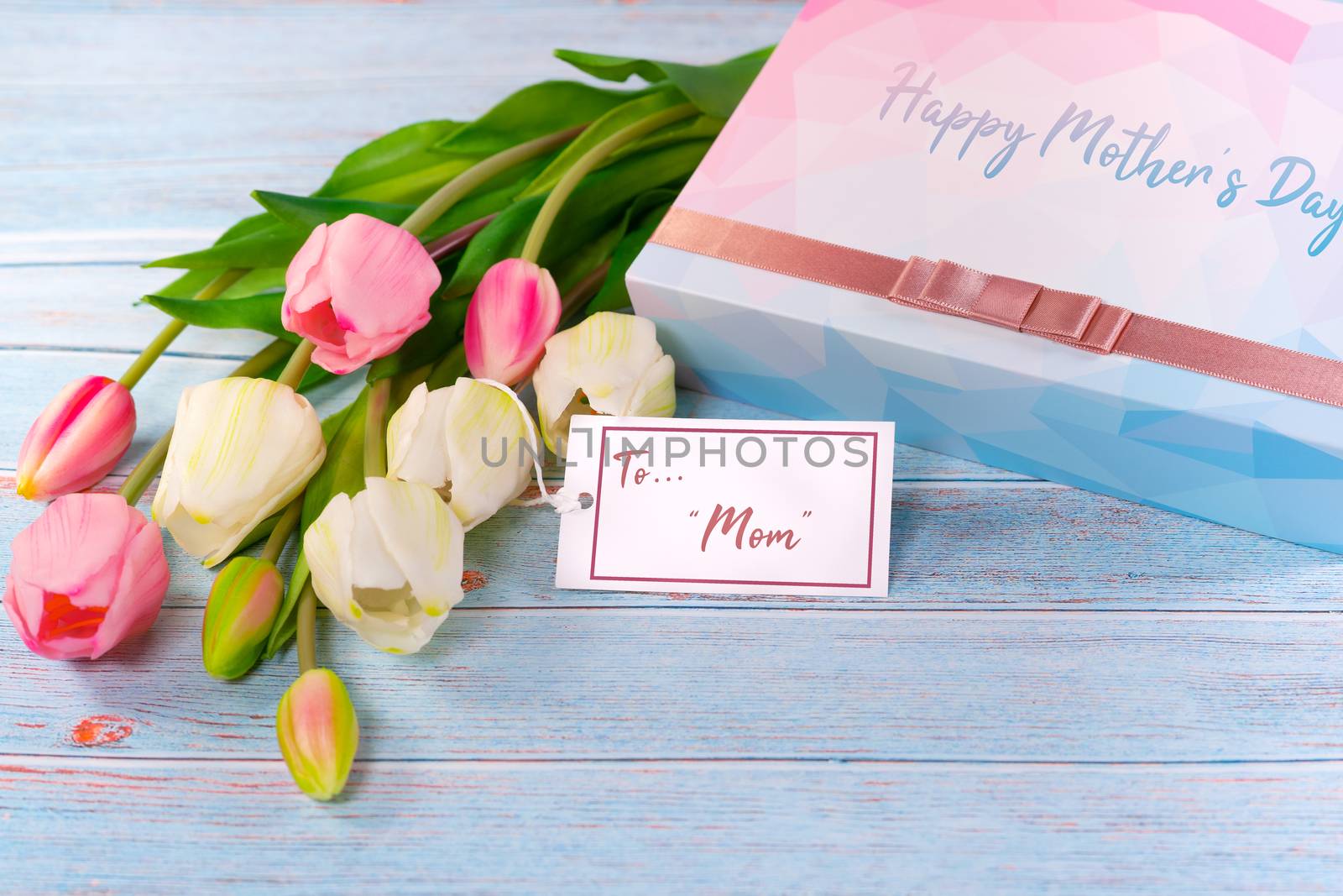 Happy mother's day concept. Gift box and flower, paper tag