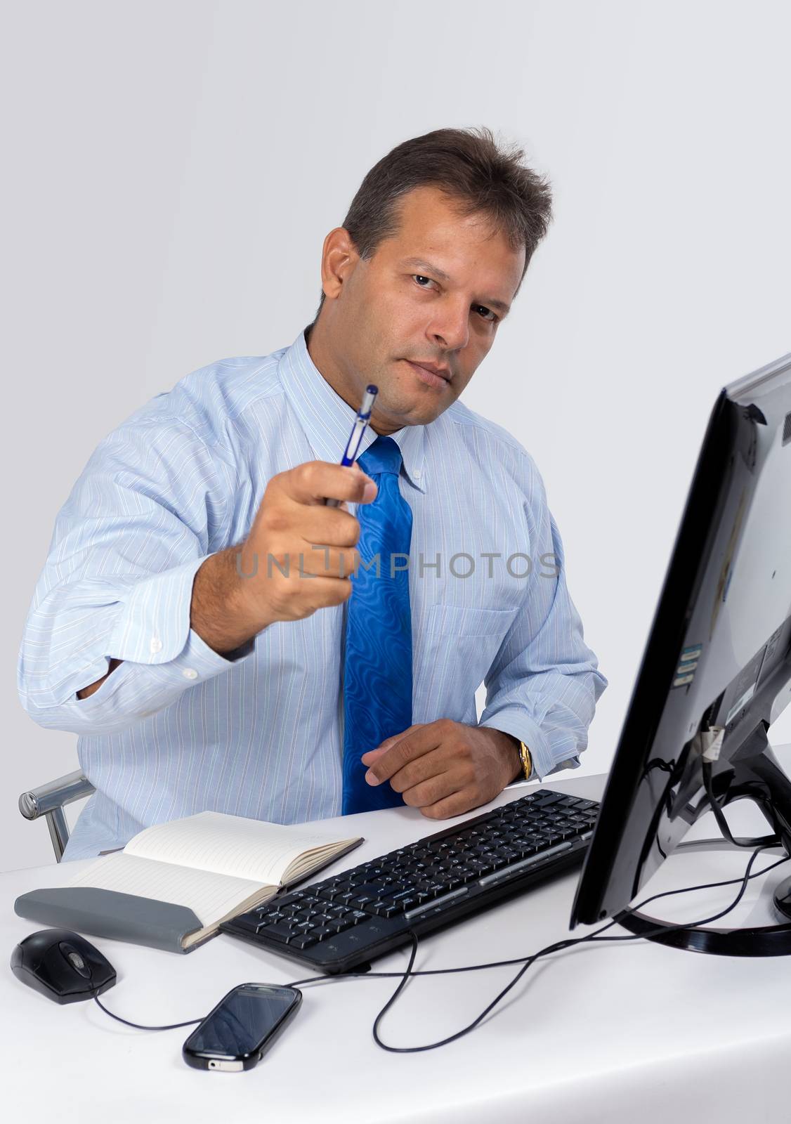 A man wearing blue shirt with a computer