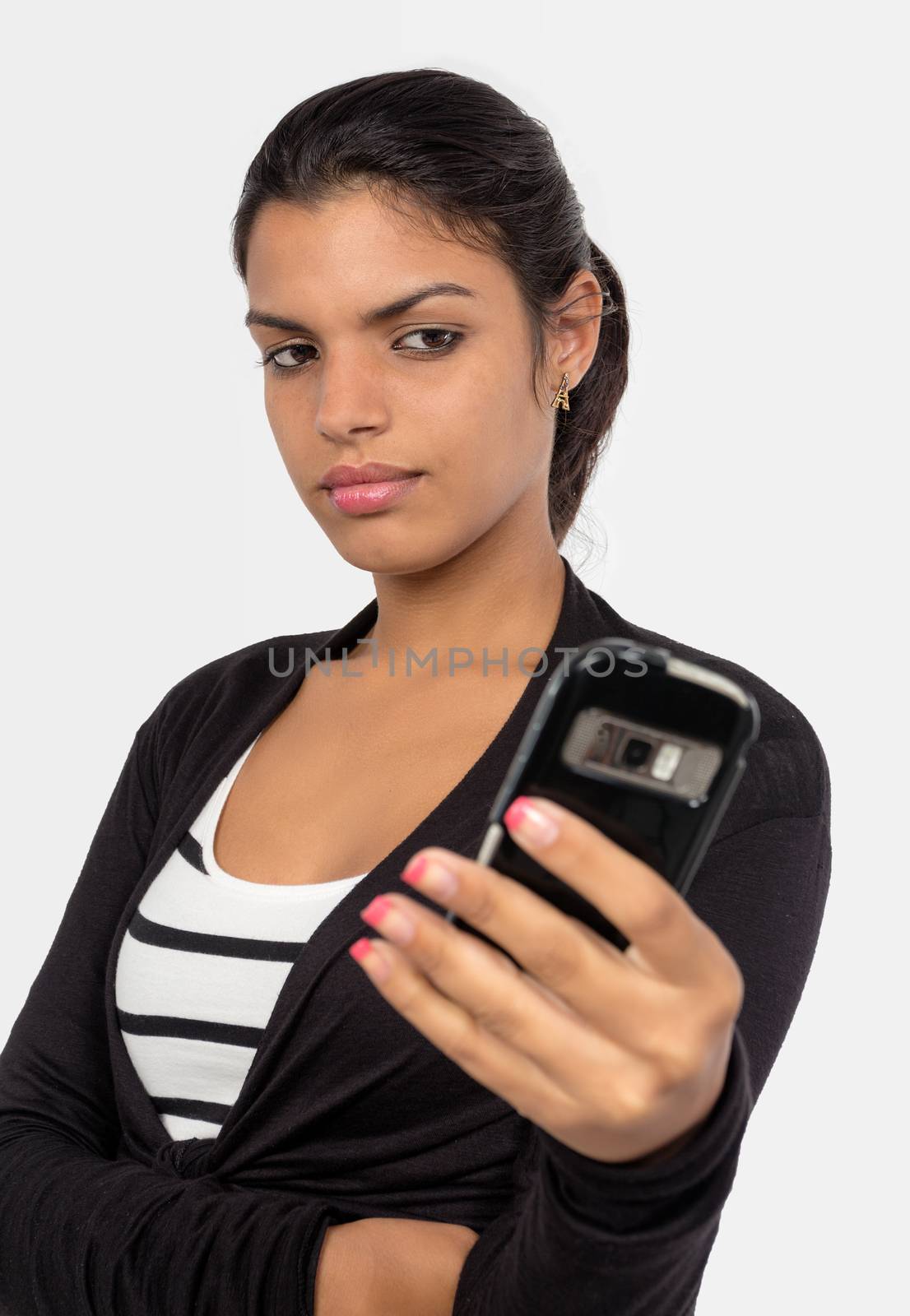 A girl with black hair looking to and holding a cellphone with her hand