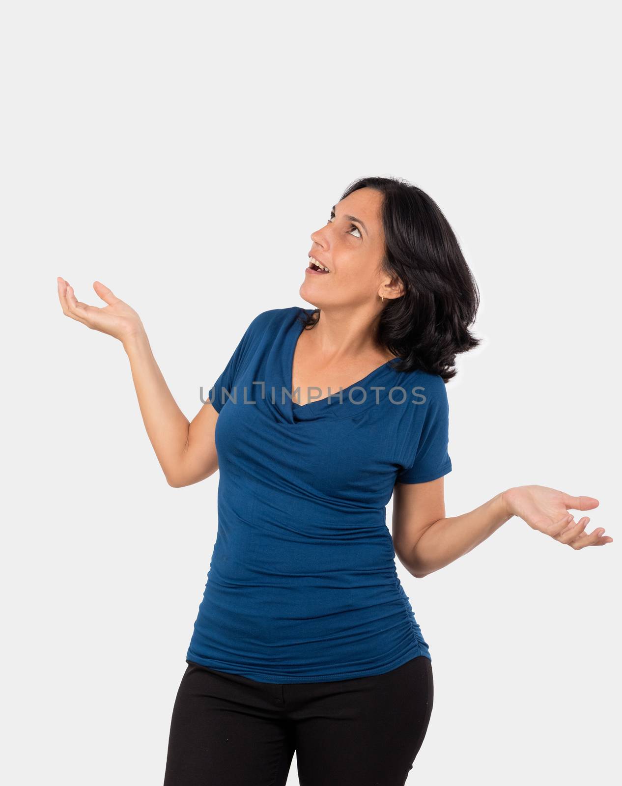 Astonished woman,with open arms and open mouth, she is wearing a blue blouse