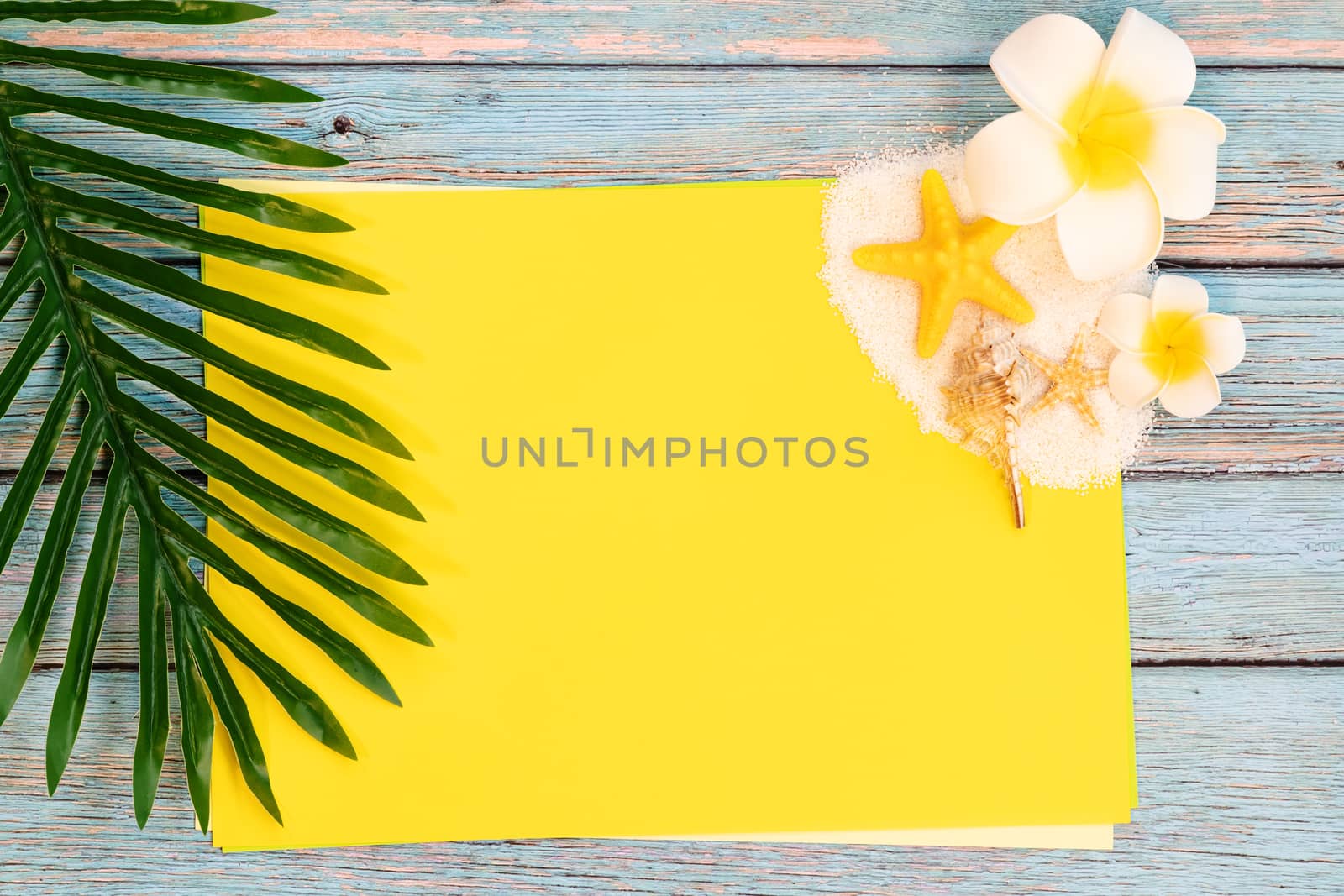 Beautiful summer holiday, Beach accessories, seashells, sand and palm leave on paper for copy space