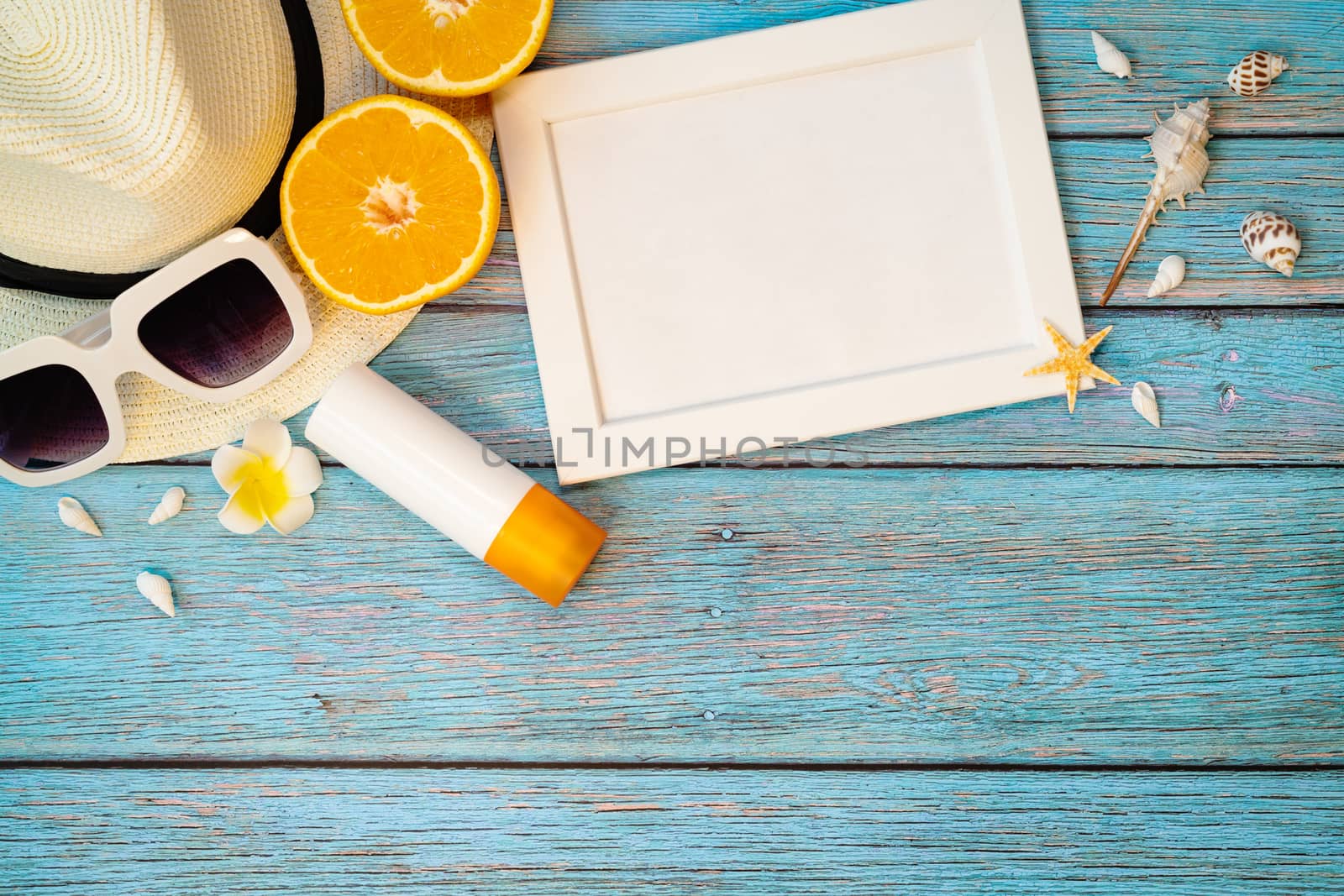 Beautiful summer holiday, Beach accessories, orange, sunglasses, hat and sunblock on wooden backgrounds