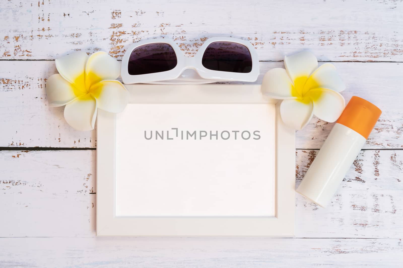 Beautiful summer holiday, Beach accessories, orange, sunglasses, flower and photo frame on wooden backgrounds