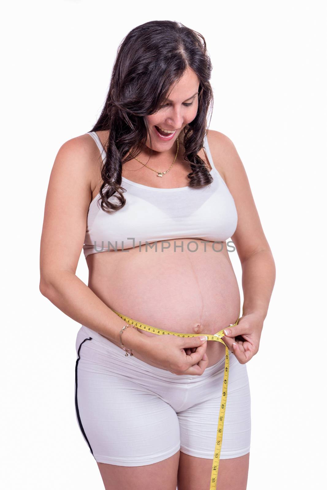 A pregnant woman measuring her belly