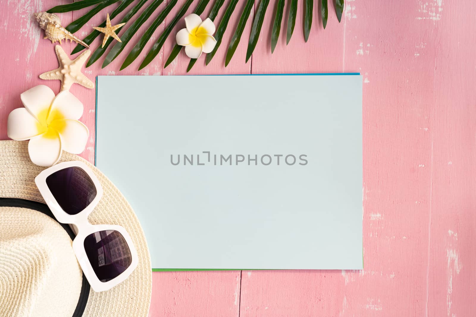 Beautiful summer holiday, Beach accessories, sea shells, hat, sunglasses and palm leave on paper for copy space