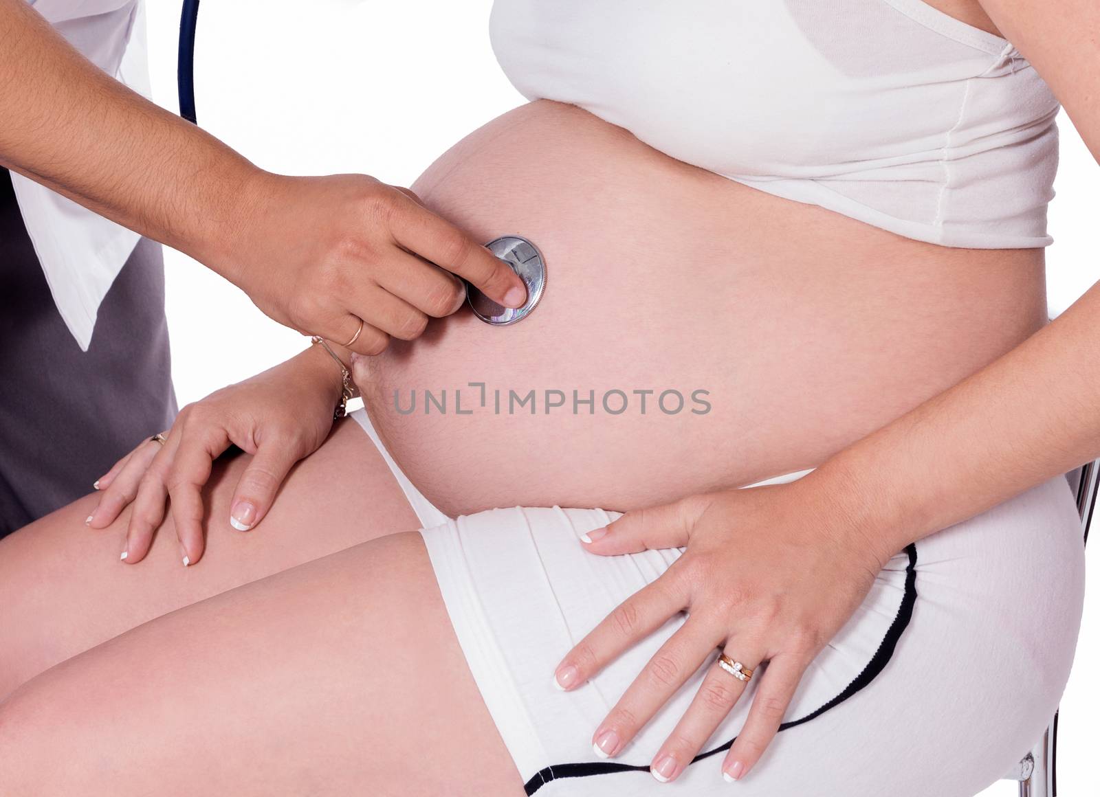 Pregnant woman being attended by a doctor