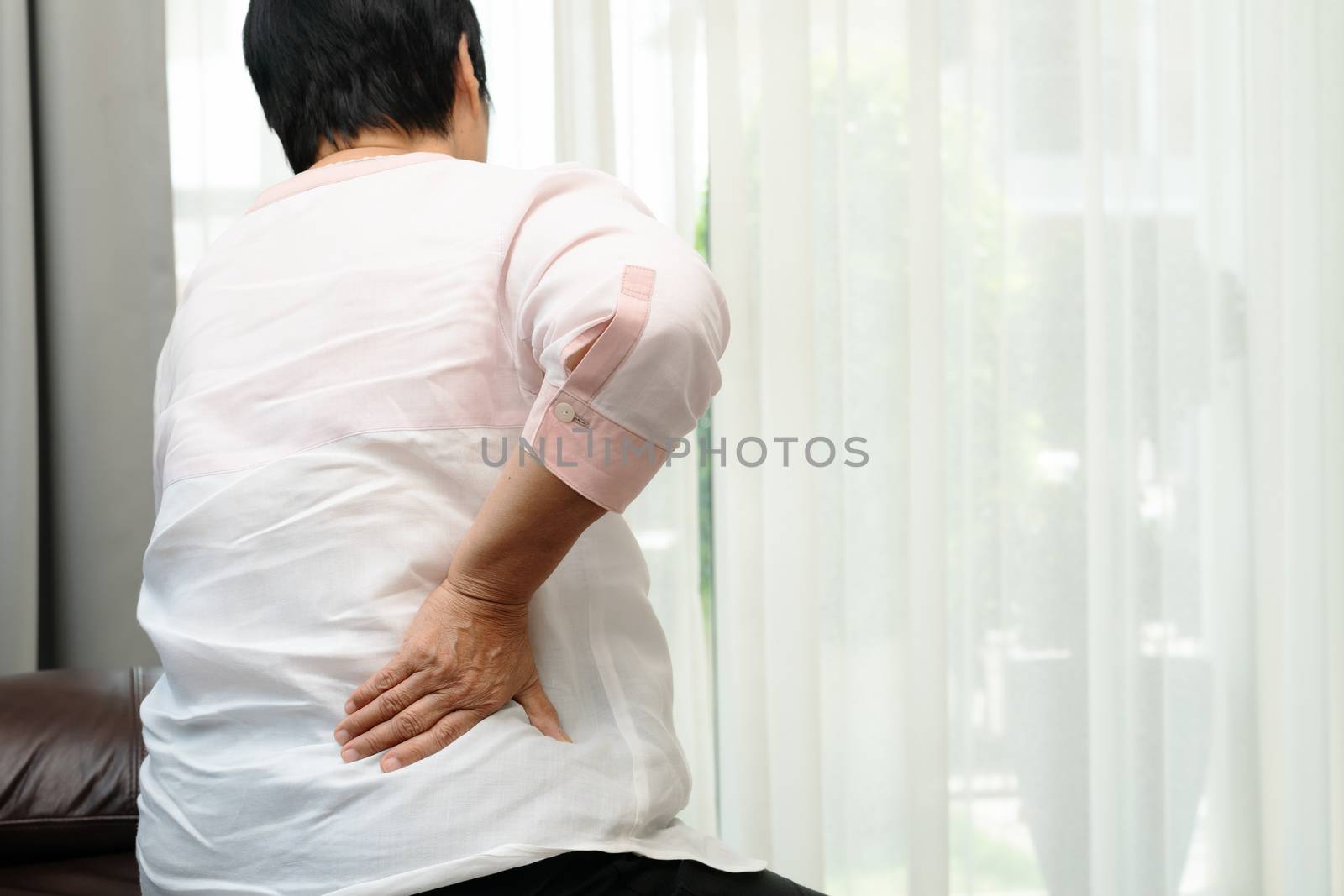 Old woman back pain at home, health problem concept