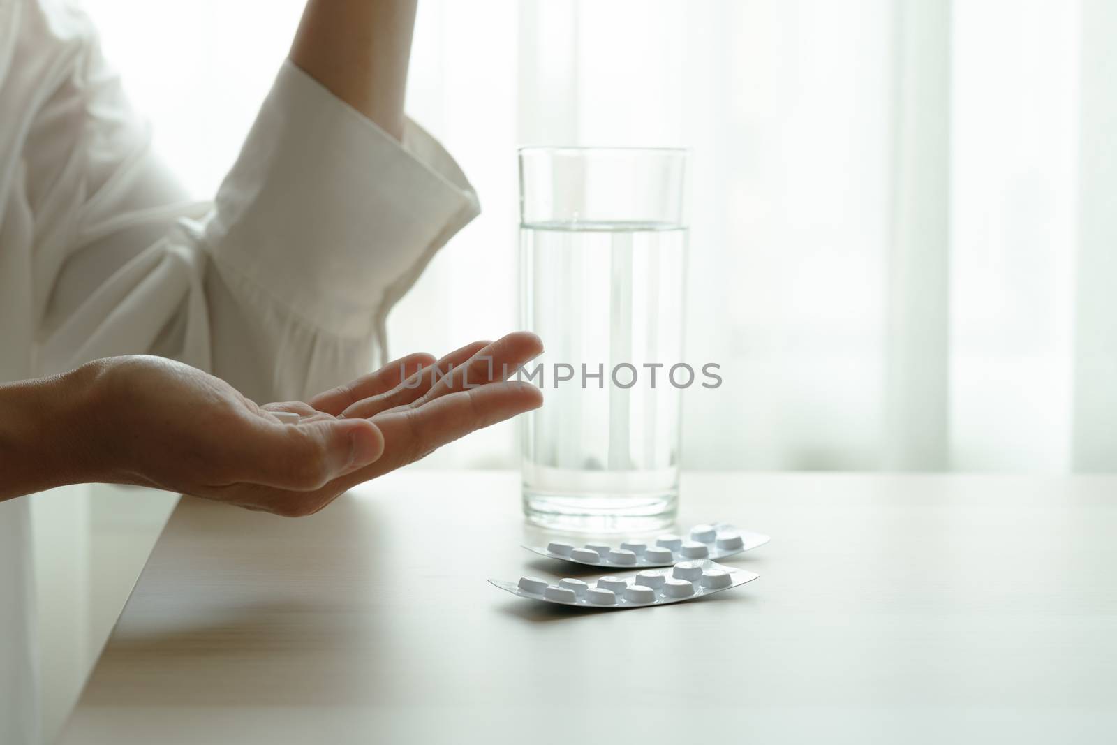 depressed women hand hold medicine with a glass of water, healthcare and medicine recovery concept