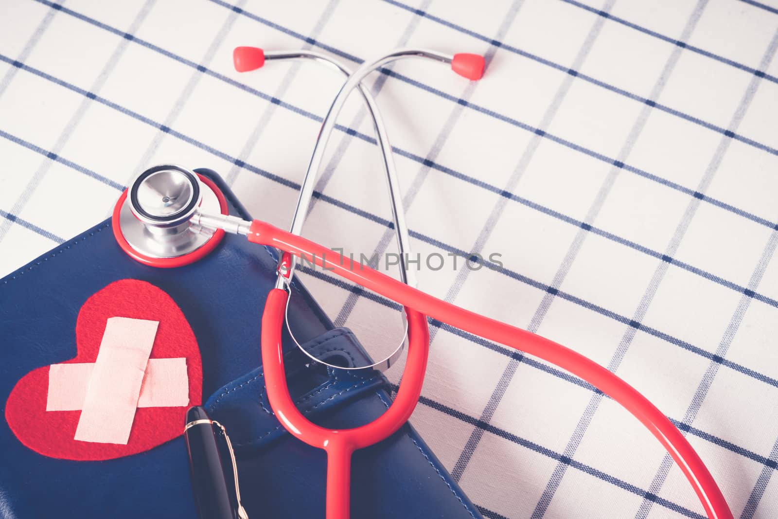 World health day healthcare and medical concept red stethoscope and red heart shape on the blue daily notebook