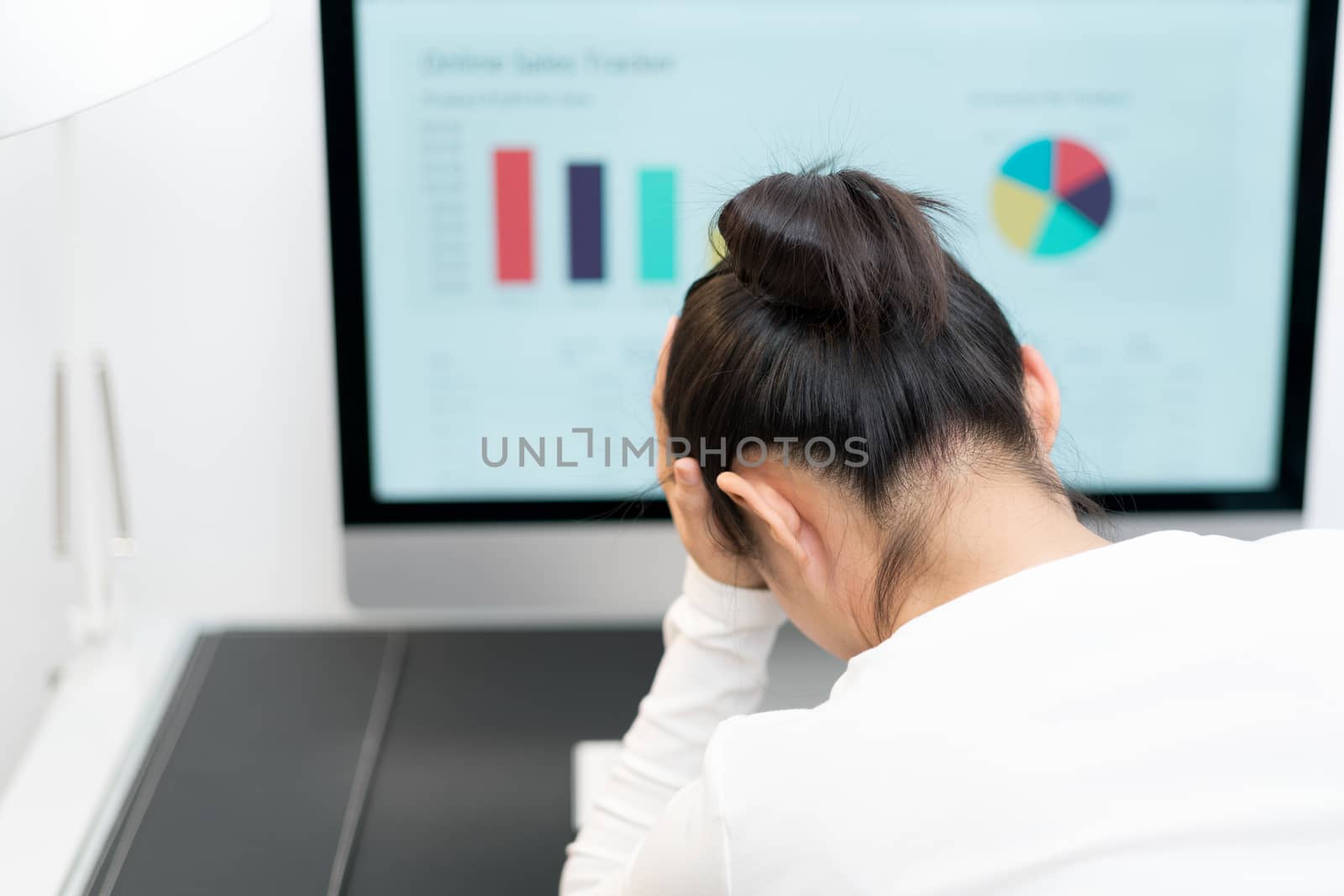 Feeling tired and stressed. young woman suffer from working while sitting at her working place in office