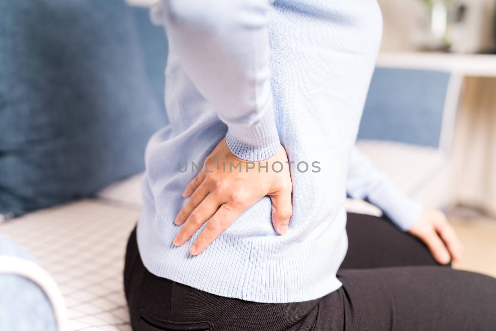 back pain at home. women suffer from backache. healthcare and medical concept