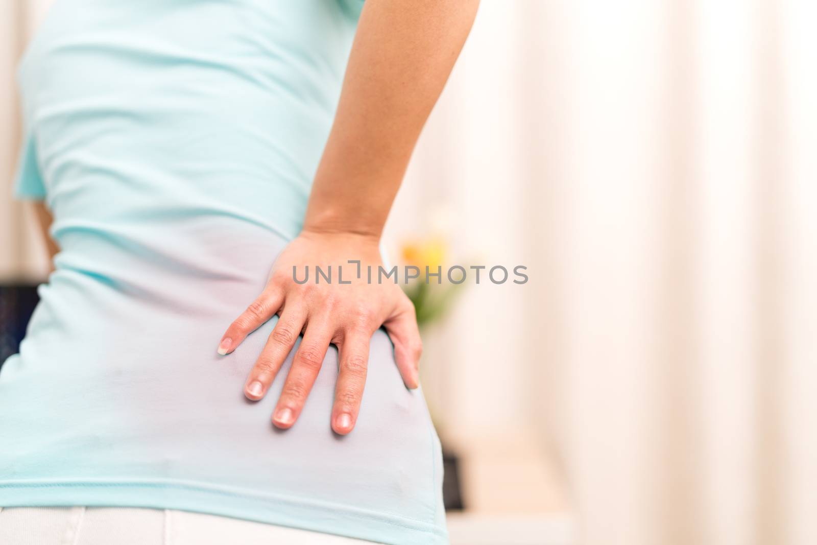 back pain at home. women suffer from backache. healthcare and medical concept