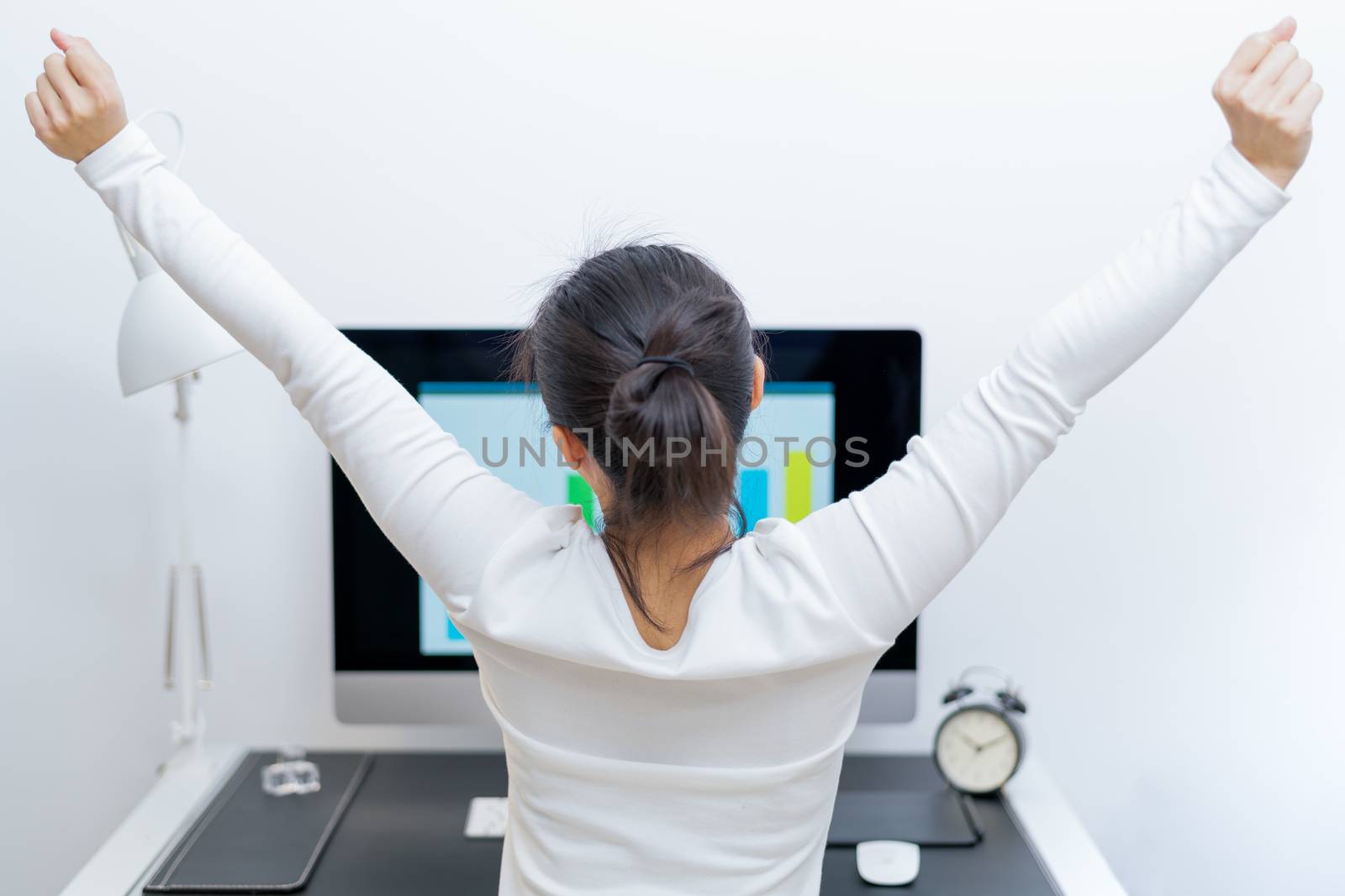 Young Asian beautiful woman sitting in front of computer and stretch oneself  after long working. stree-free and relax