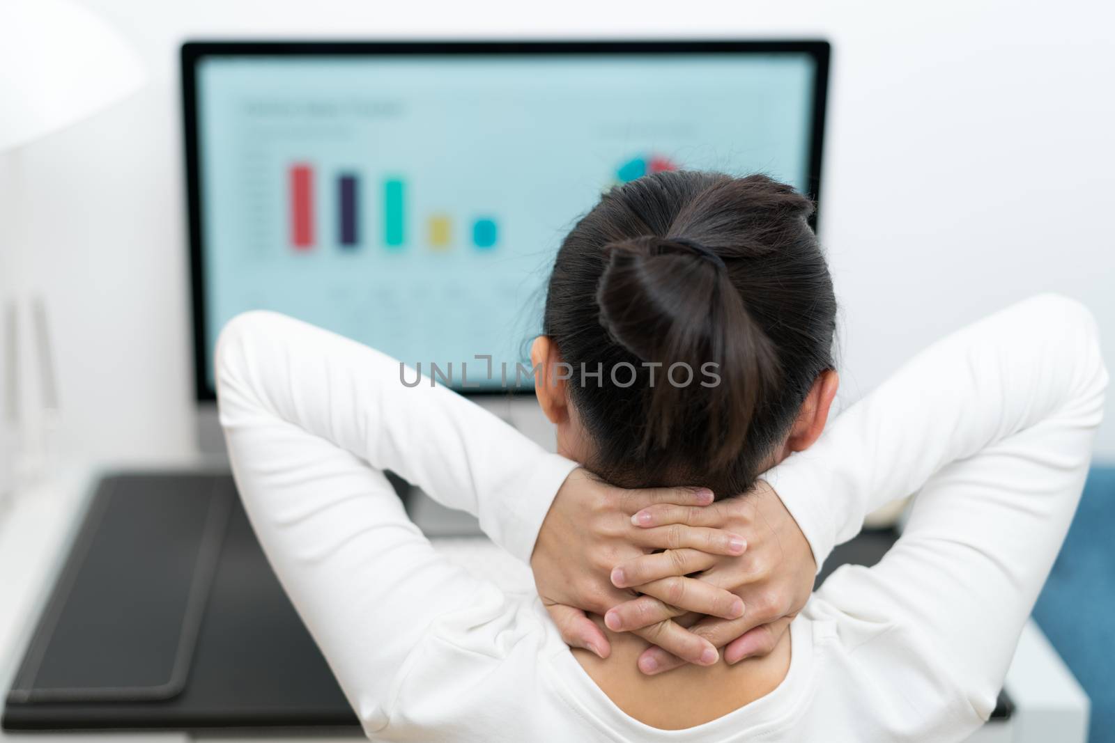 young business woman thinking while working on desktop computer at modern home office