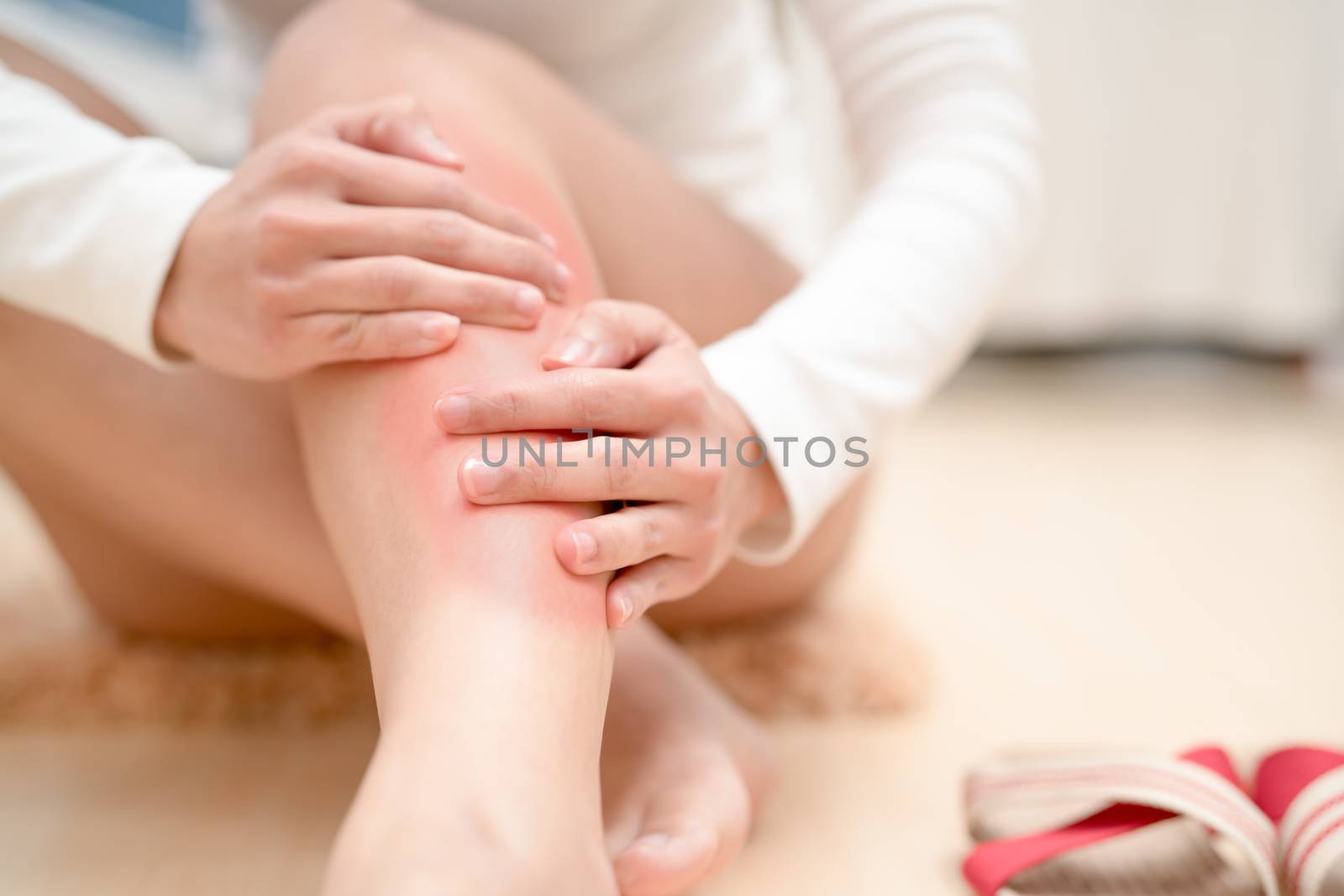 leg ankle injury painful women touching the leg painful with red highlight on injure. healthcare and medical concept