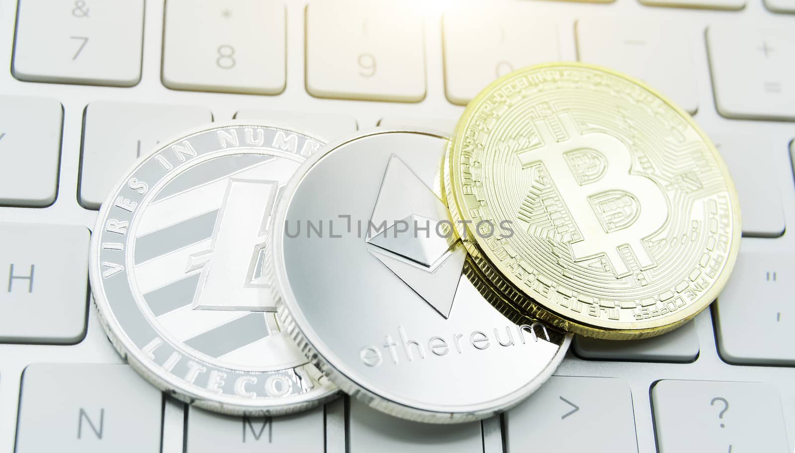 cryptocurrency coins - Litecoin, Bitcoin, Ethereum, Ripple cryptocurrency concept stock of physical bitcoins gold and silver coins
