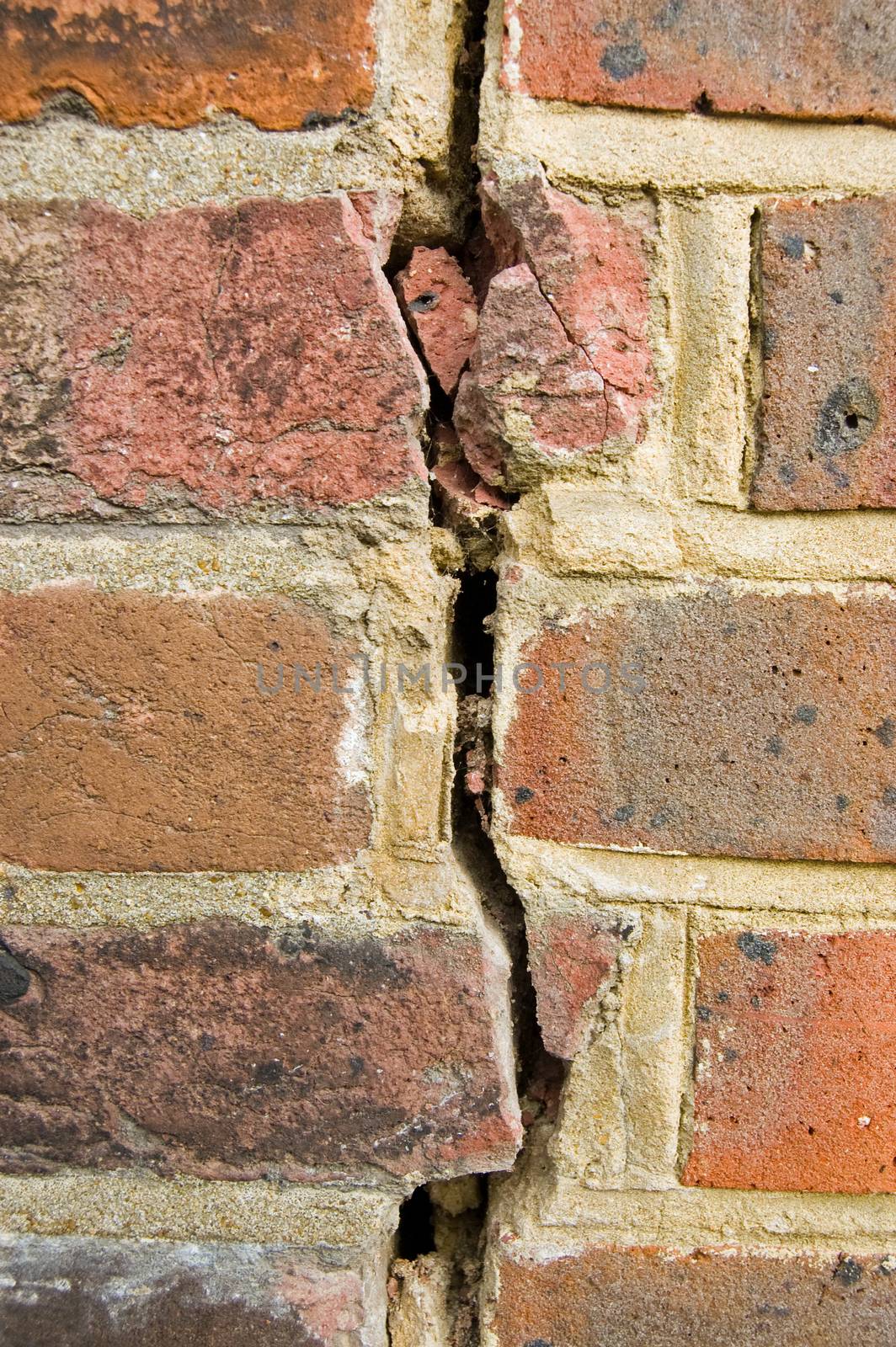 A vertical crack in a brick wall.