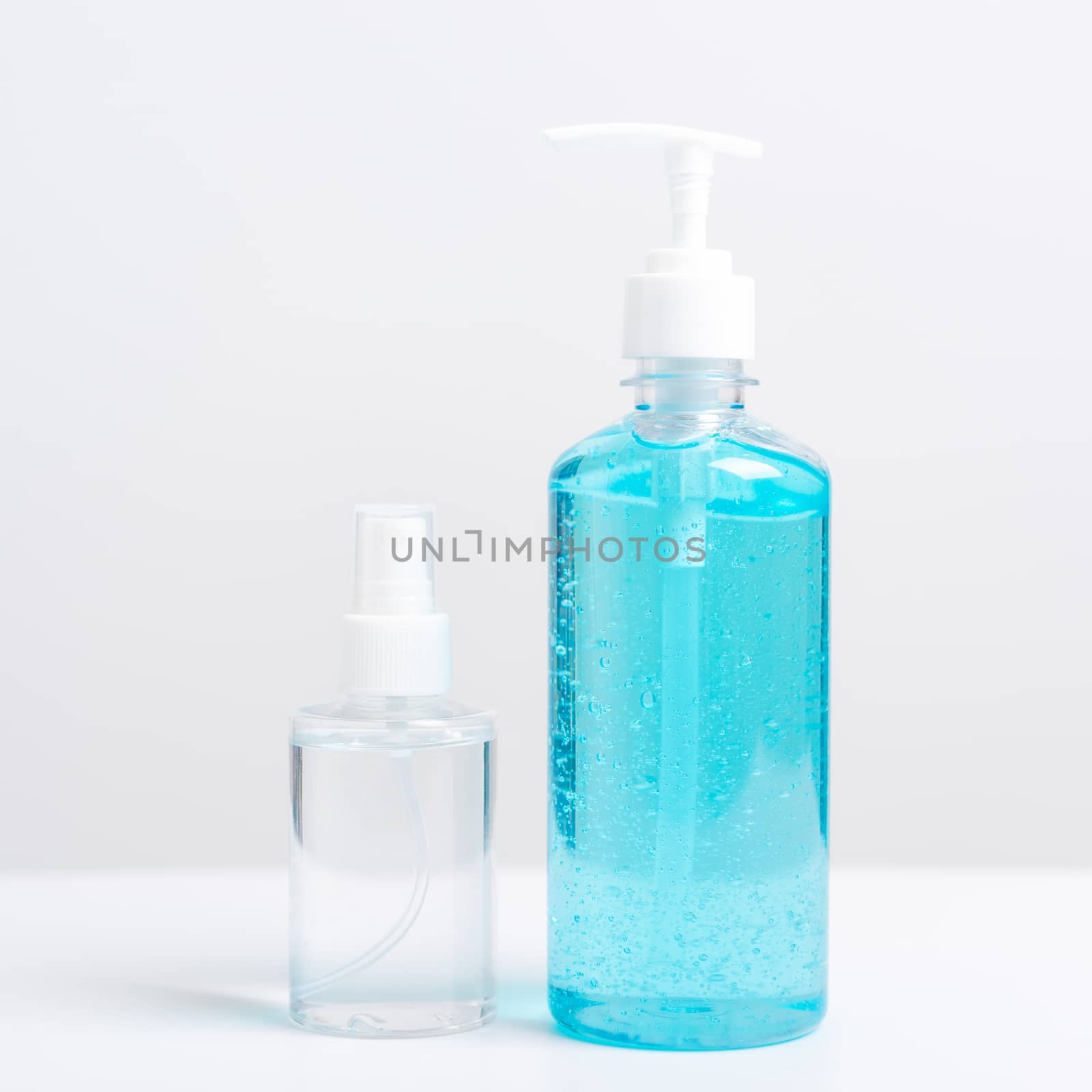 Plastic dispenser sanitizer alcohol gel pump and spray bottle for washing hand hygiene prevention of coronavirus virus studio shot on white background