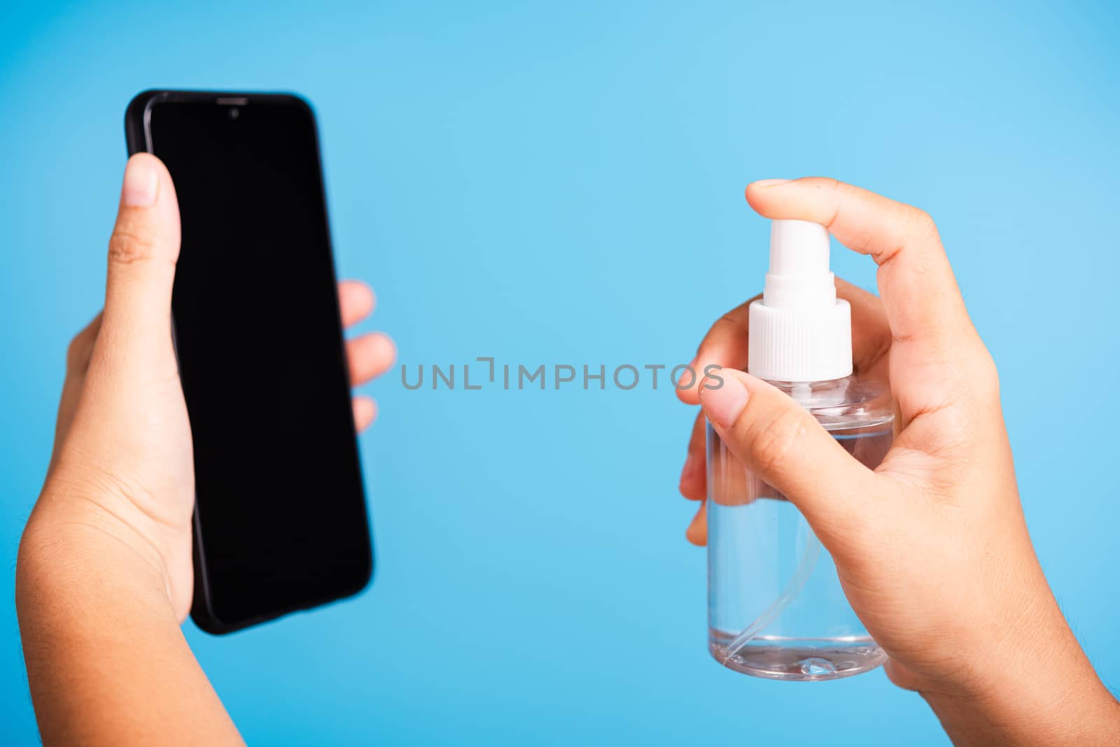 woman applying press dispenser sanitizer alcohol spray squirt to by Sorapop