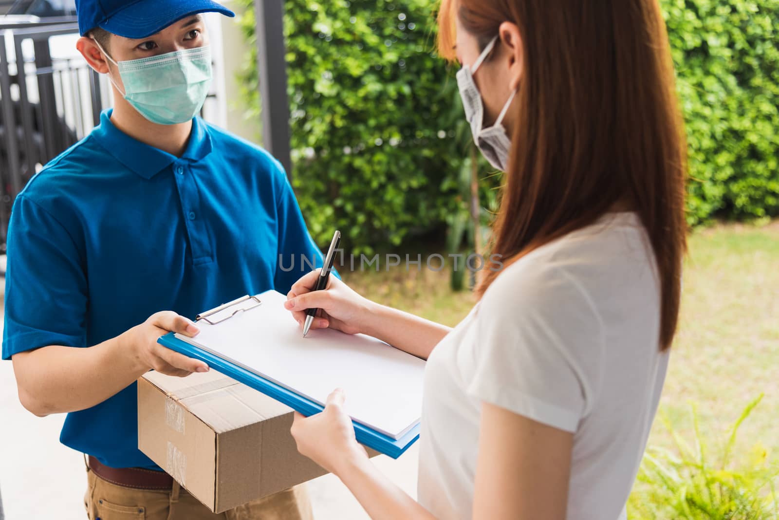 delivery man courier in uniform protective face mask coronavirus by Sorapop