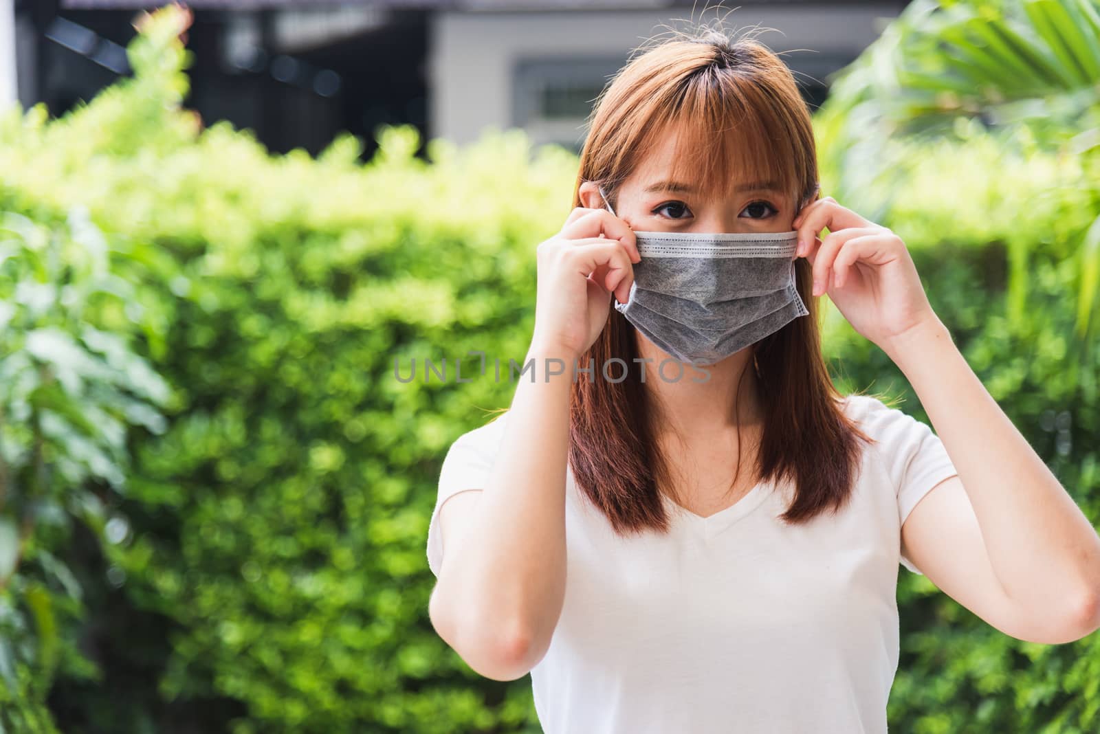 woman wearing face mask protective outdoor by Sorapop