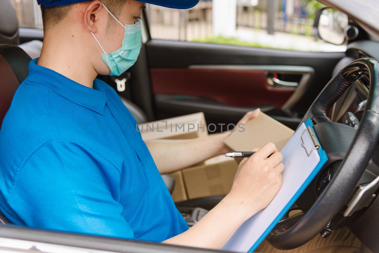 delivery courier young man driver inside the van car with parcel by Sorapop