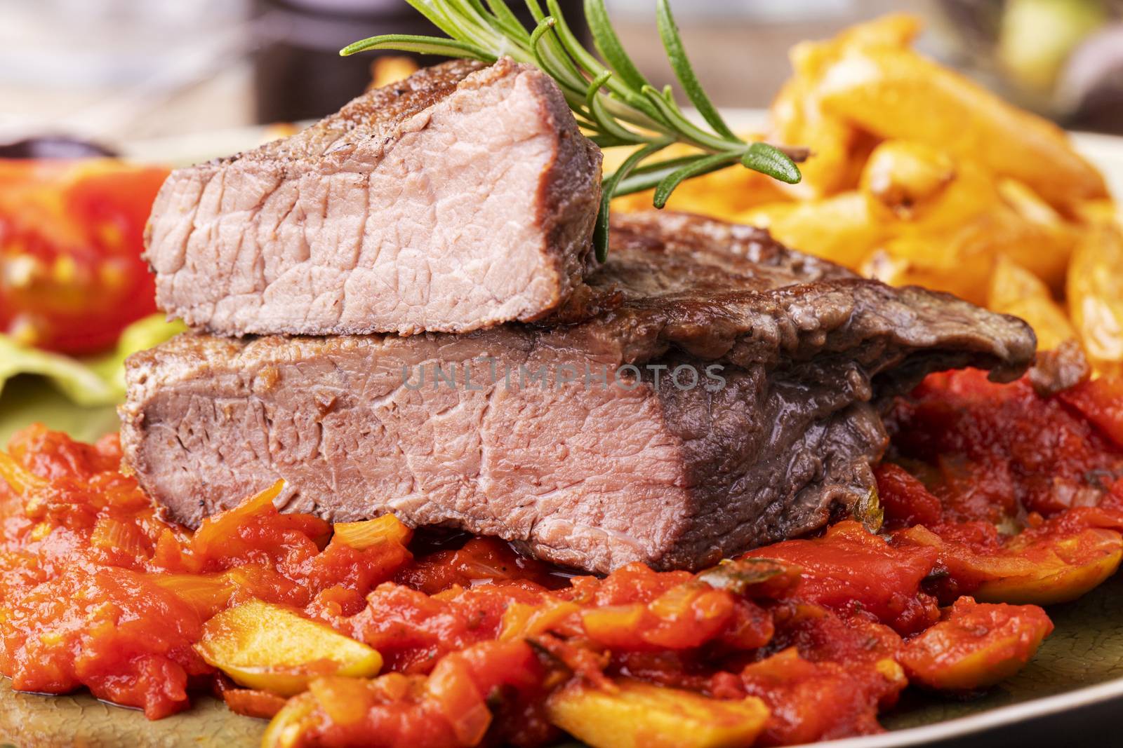 grilled steak on a plate with rosemary