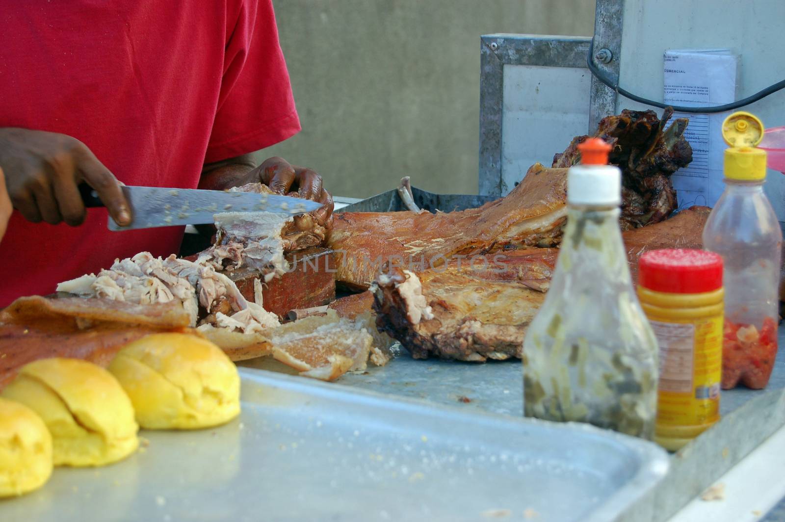 A vendor making one of Cuba's favourite street foods, pork rolls. Havana, Cuba.