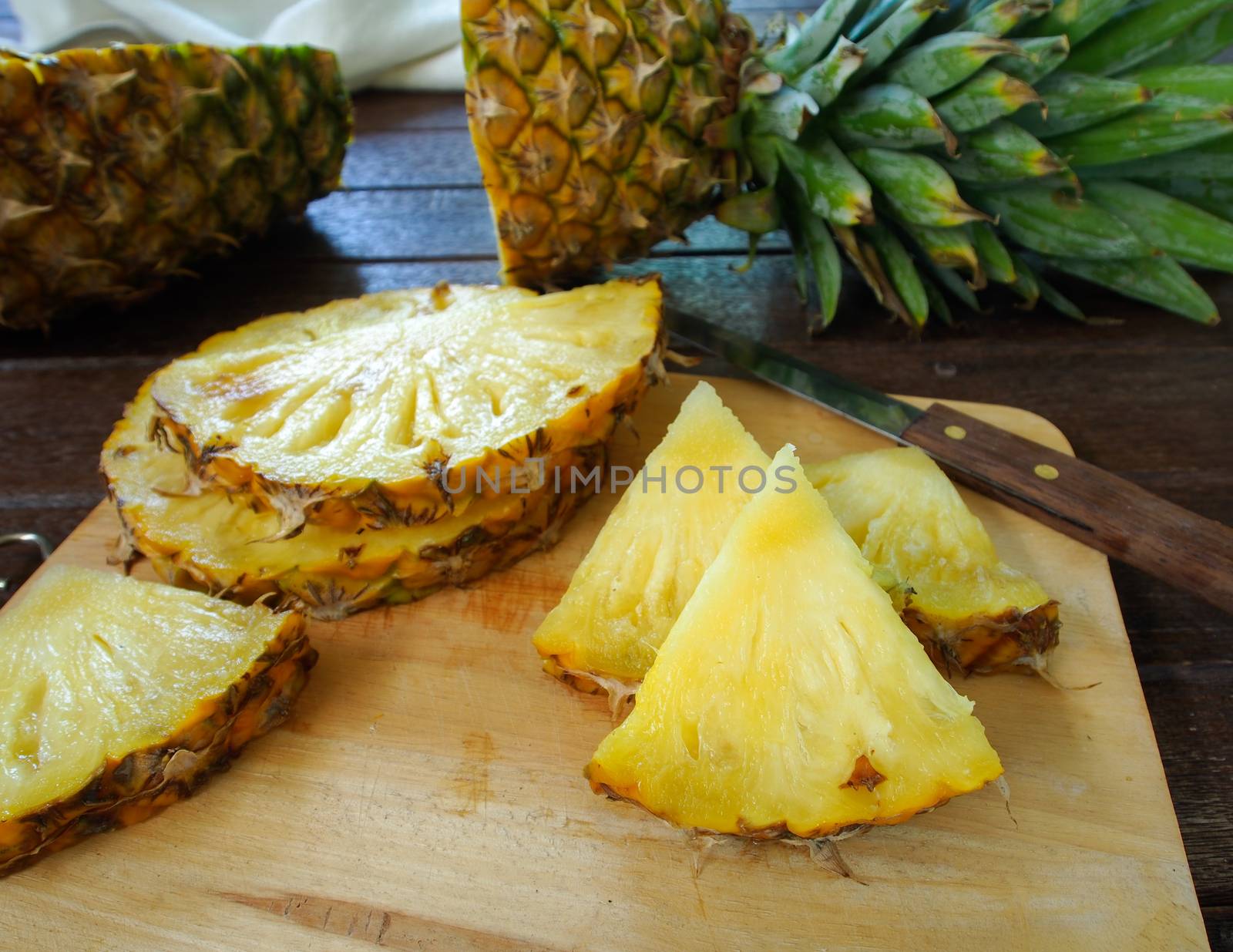 Pineapple slices on a wooden cutting board