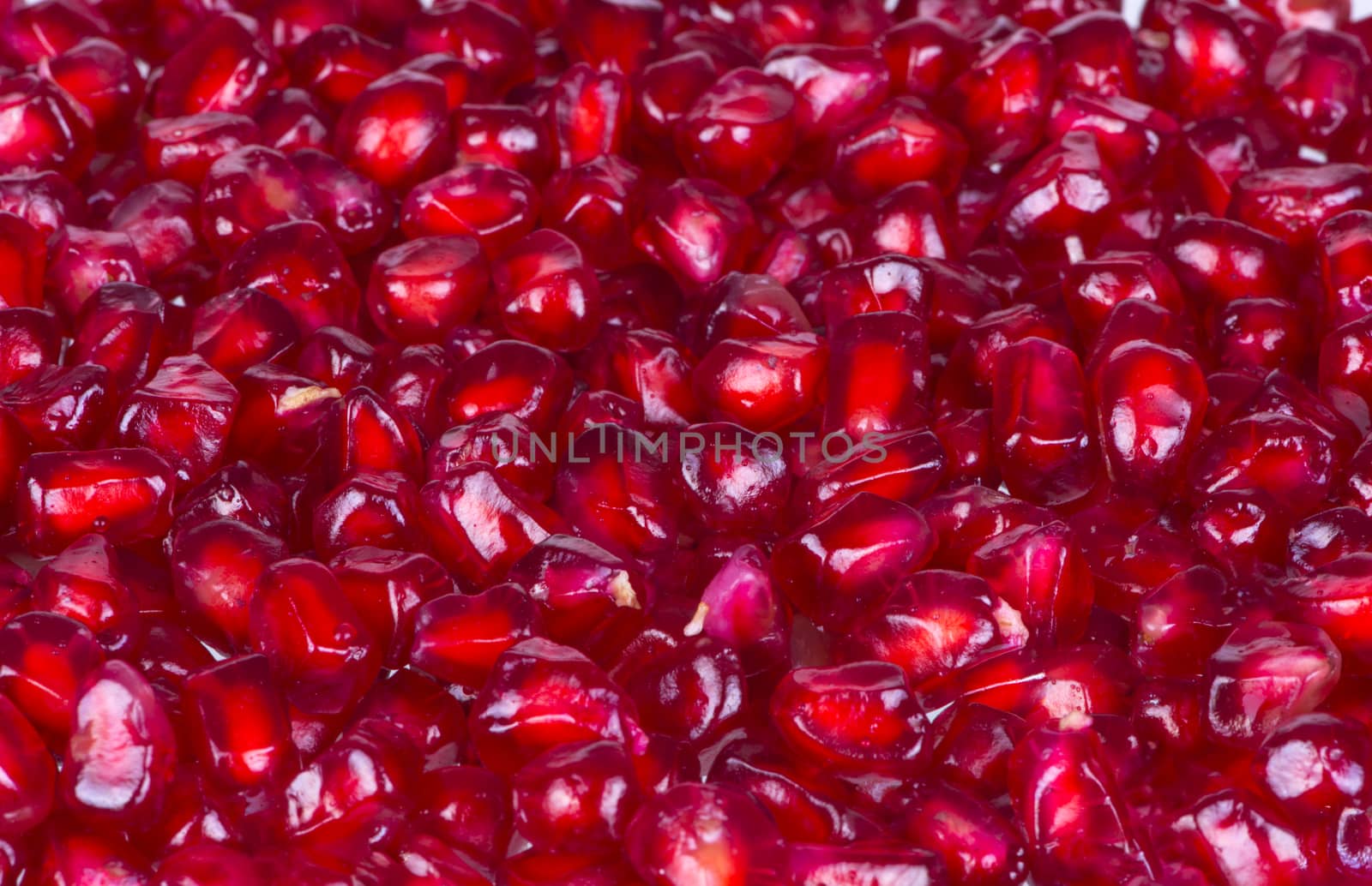 Closeup fresh pomegranate seeds for food background.