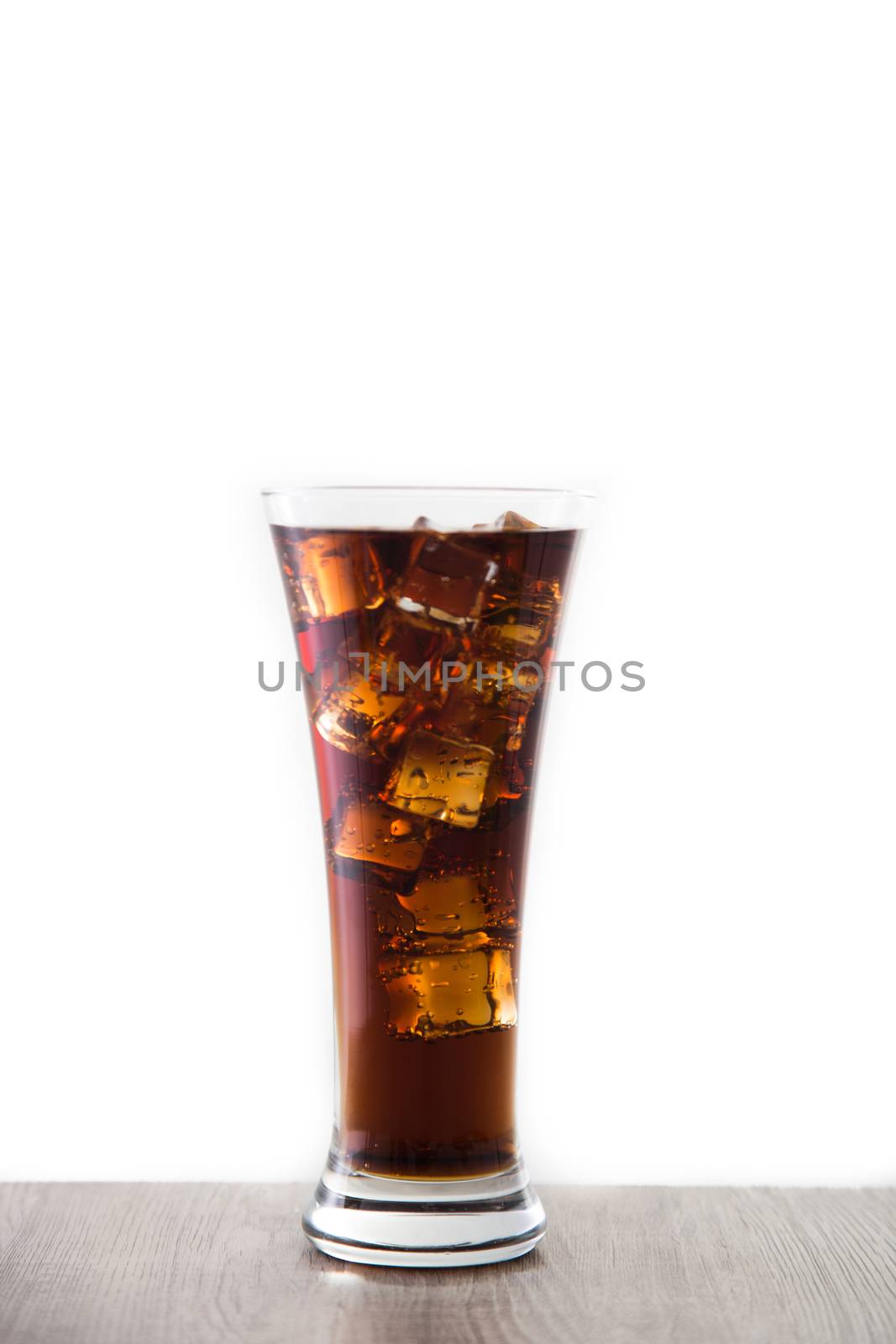a glass of soft drink on wooden table