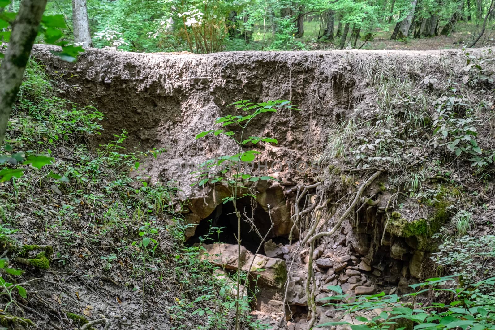 The collapsed edge of the road from the rain. Akyduct for water runoff.