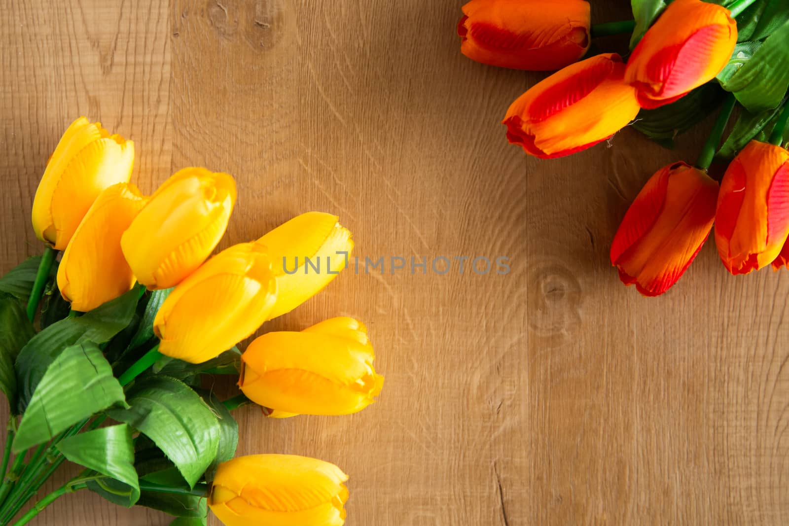 Tulips bunch on wooden background. Space for text.
