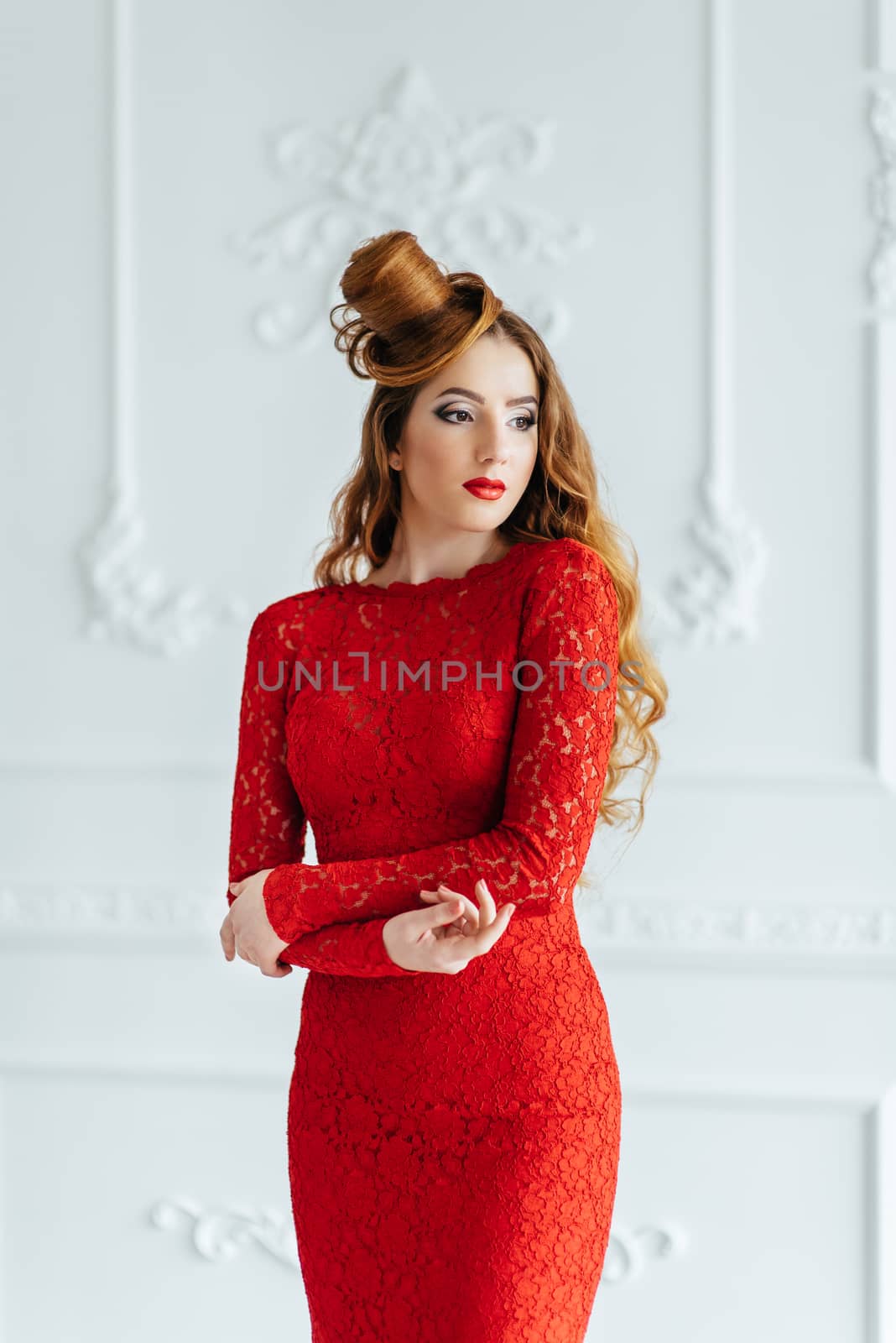 young girl with red hair in a bright red dress in a light room by Andreua