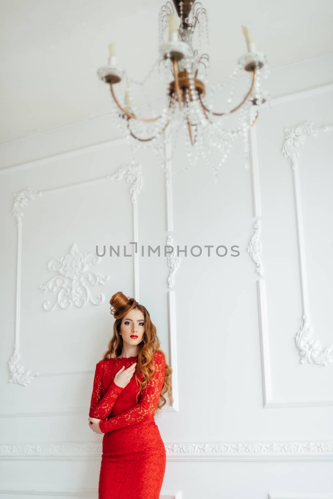 young girl with red hair in a bright red dress in a light room by Andreua