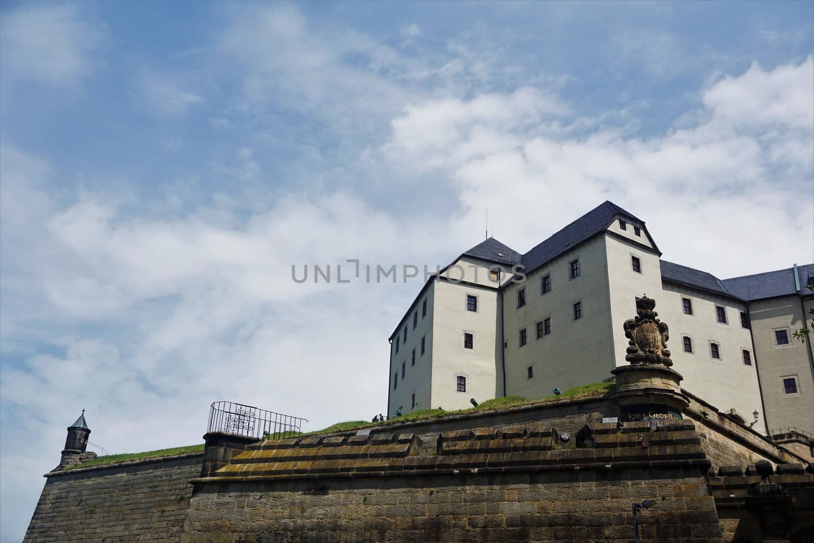 Koenigstein fortress and part of the surrounding wall in front of sky by pisces2386