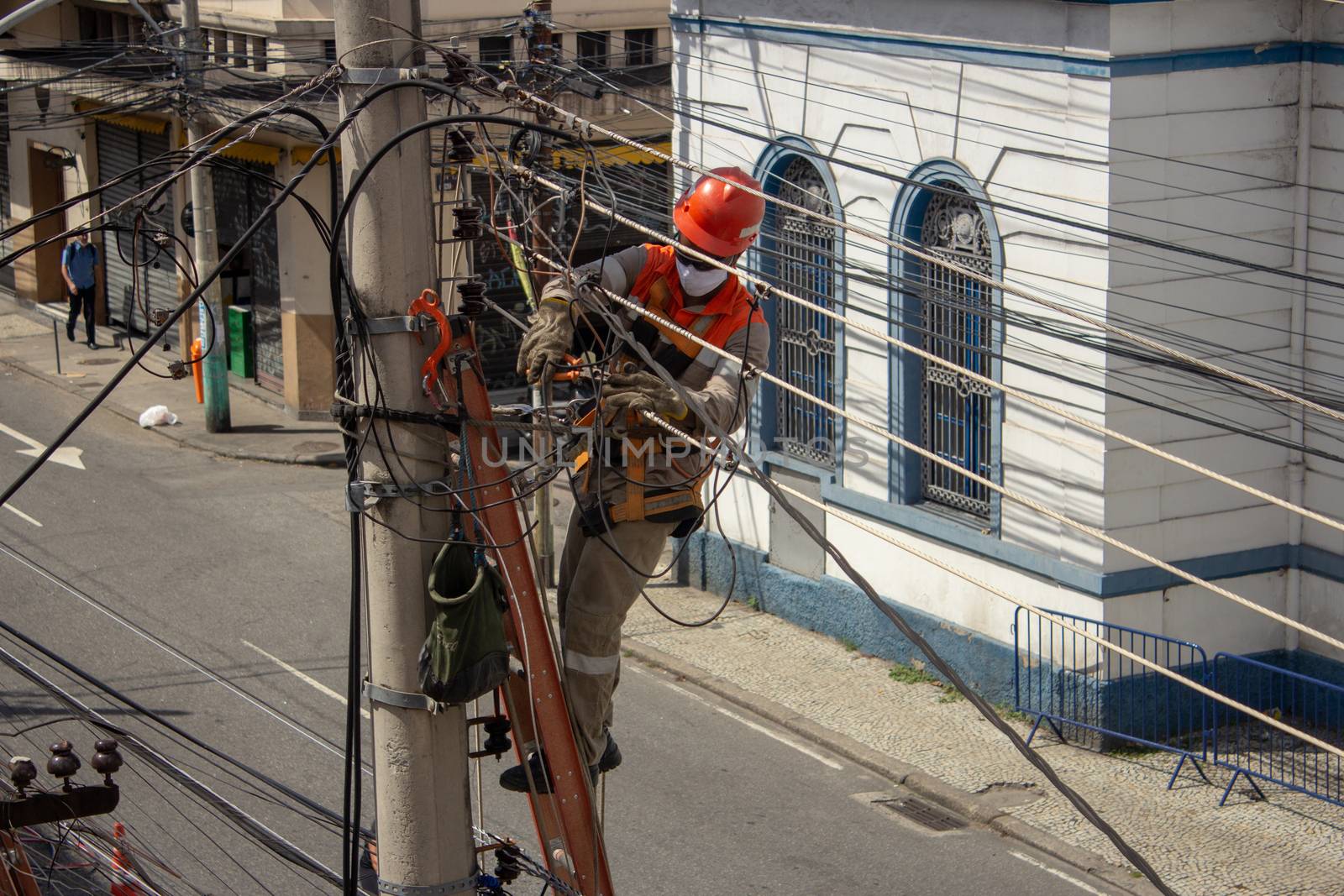 Men repairing electrical grid wires using masks because of COVID-19 by etcho